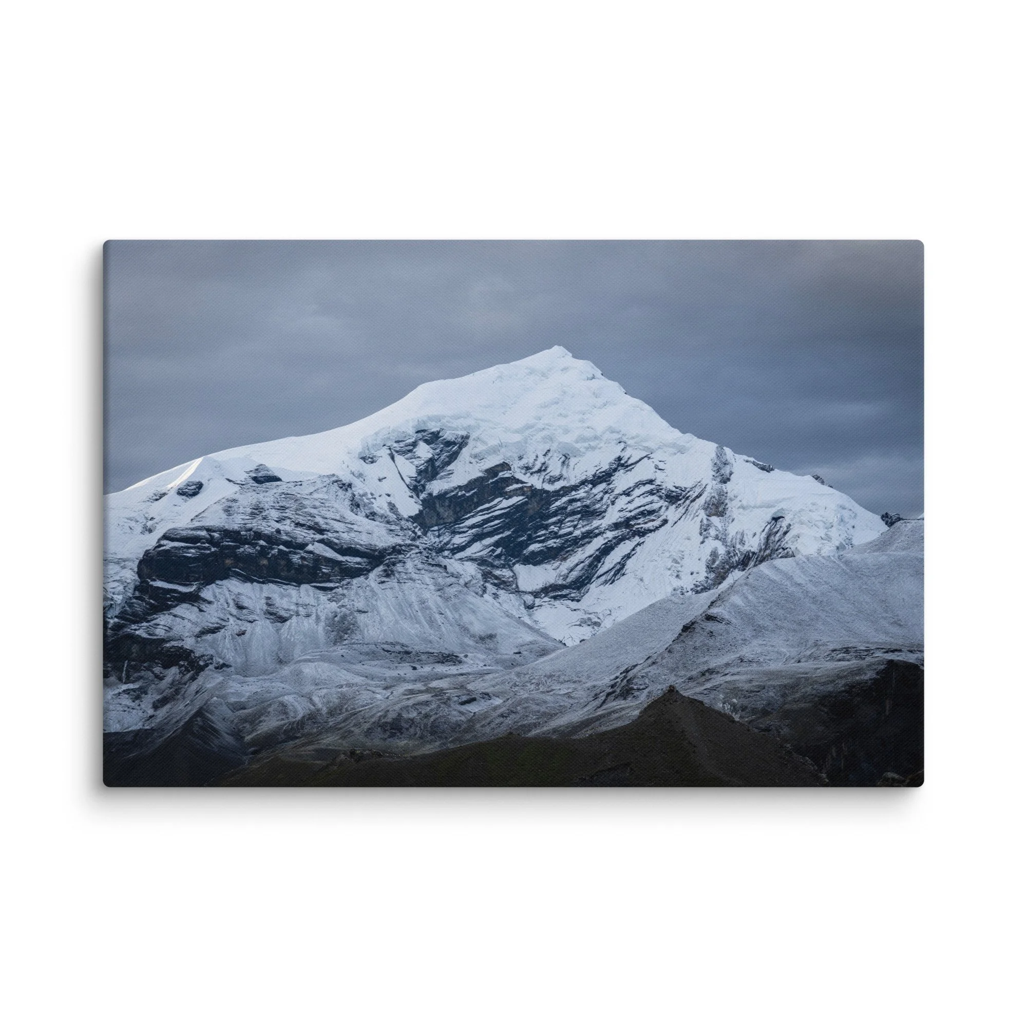 Snow-covered Himalayan summit on the Annapurna Circuit, Nepal with dramatic ridges and moody sky – high-altitude trekking travel photography canvas print wall art decor