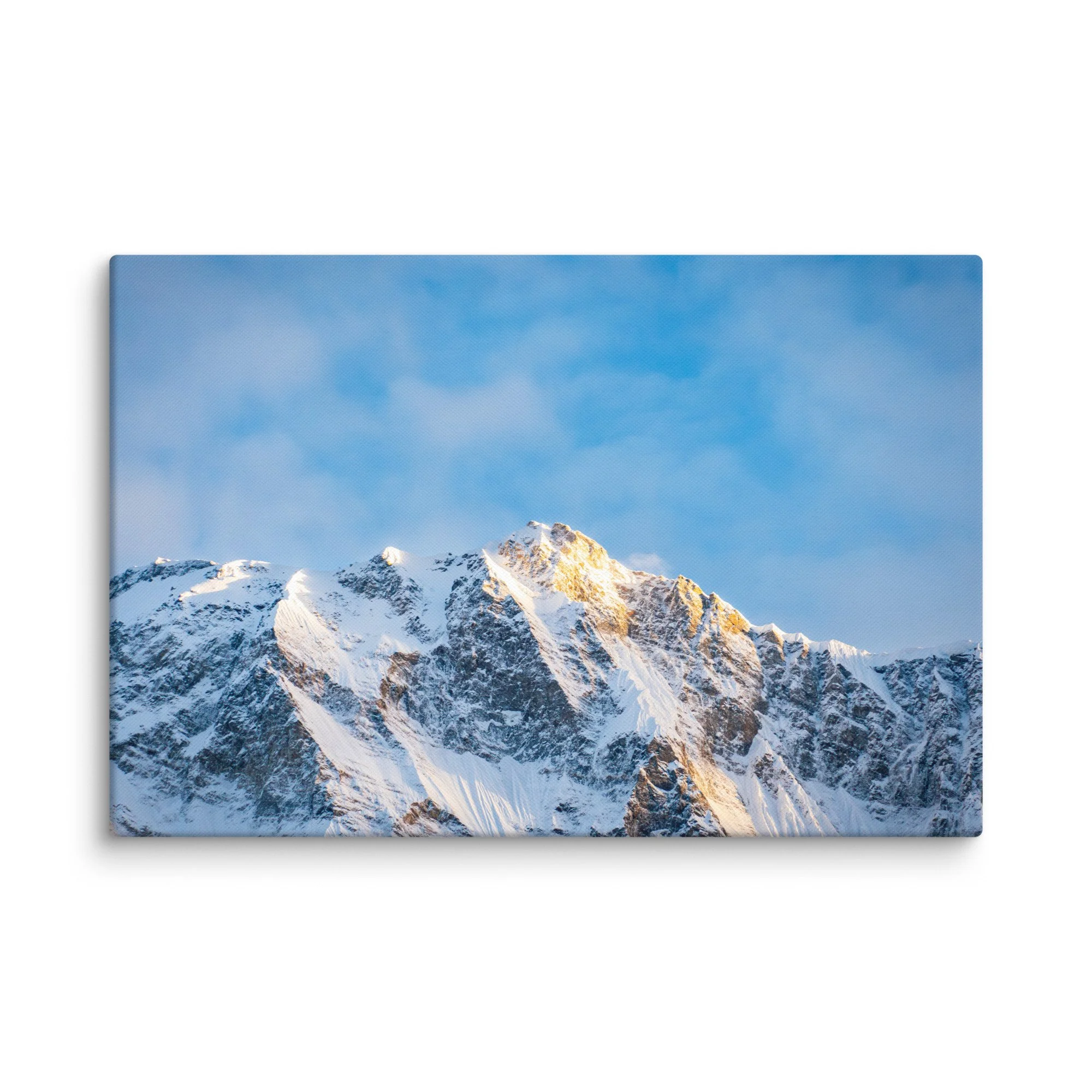 Majestic snow-covered Himalayan peak (Annapurna South or Machhapuchhre) glowing in golden sunset light through clouds at Annapurna Base Camp, Nepal – high-altitude trekking spiritual