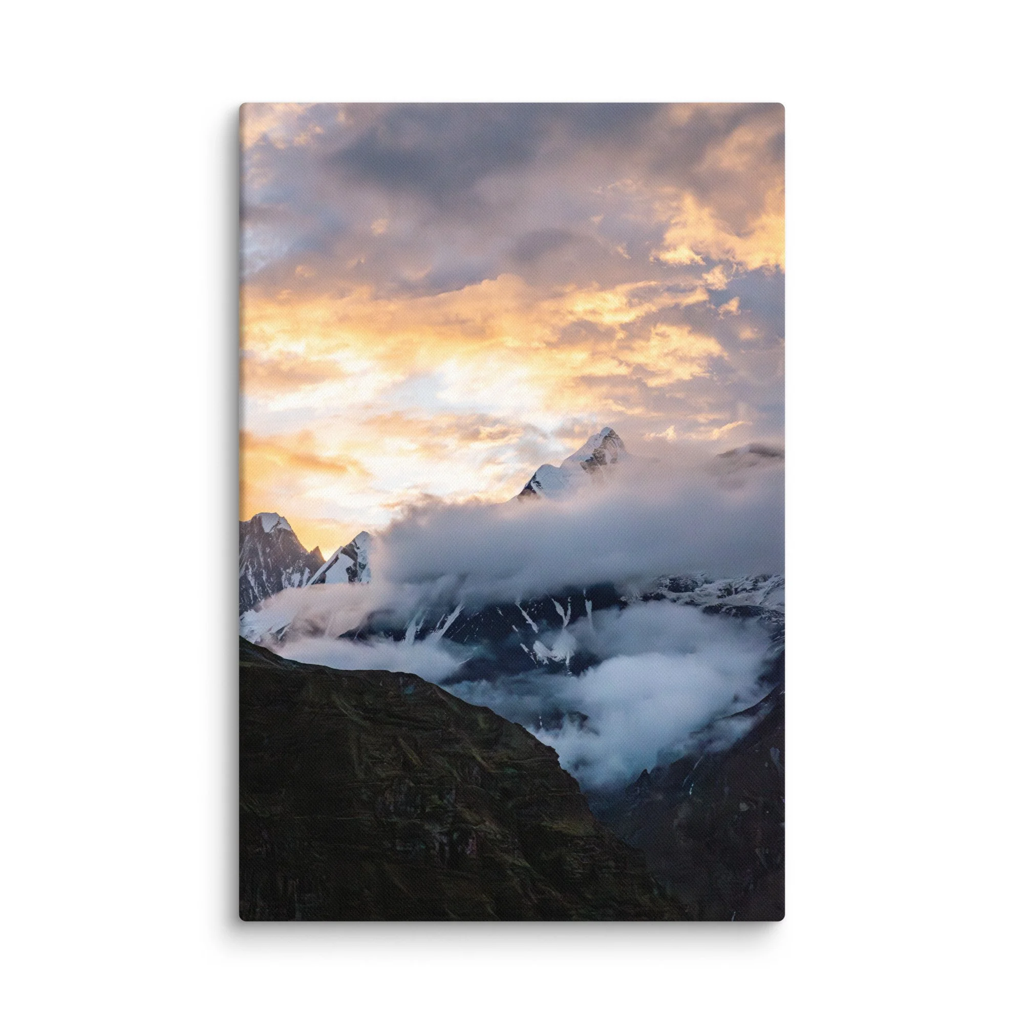 Dramatic snow-covered Himalayan peaks (Annapurna South and Machhapuchhre) glowing in golden sunset light through clouds at Annapurna Base Camp, Nepal – high-altitude trekking
