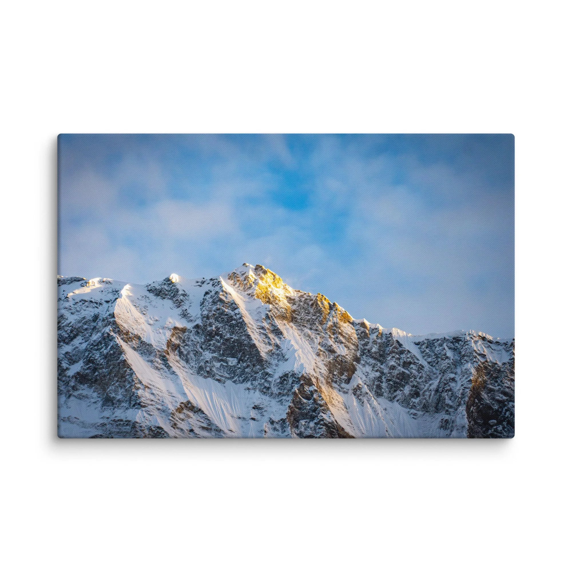 Dramatic snow-covered Himalayan peaks (Annapurna South and Machhapuchhre) glowing in golden sunset light through clouds at Annapurna Base Camp, Nepal – high-altitude trekking