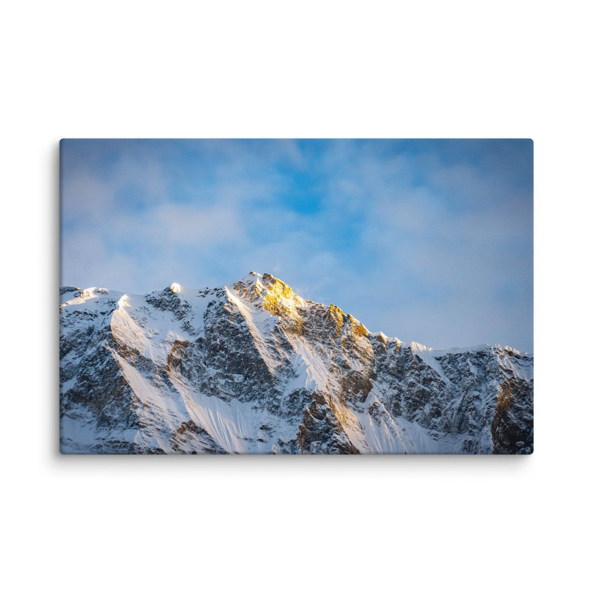 Dramatic snow-covered Himalayan peaks (Annapurna South and Machhapuchhre) glowing in golden sunset light through clouds at Annapurna Base Camp, Nepal – high-altitude trekking
