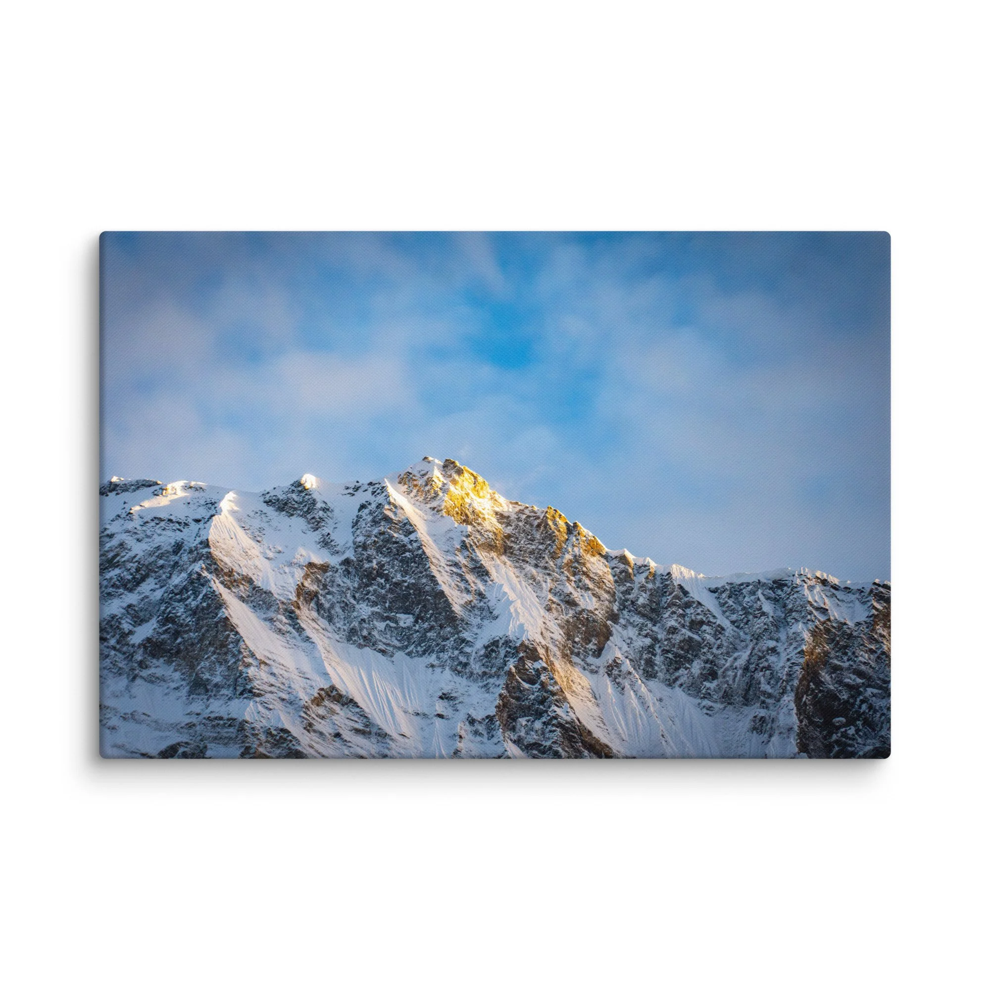 Dramatic snow-covered Himalayan peaks (Annapurna South and Machhapuchhre) glowing in golden sunset light through clouds at Annapurna Base Camp, Nepal – high-altitude trekking