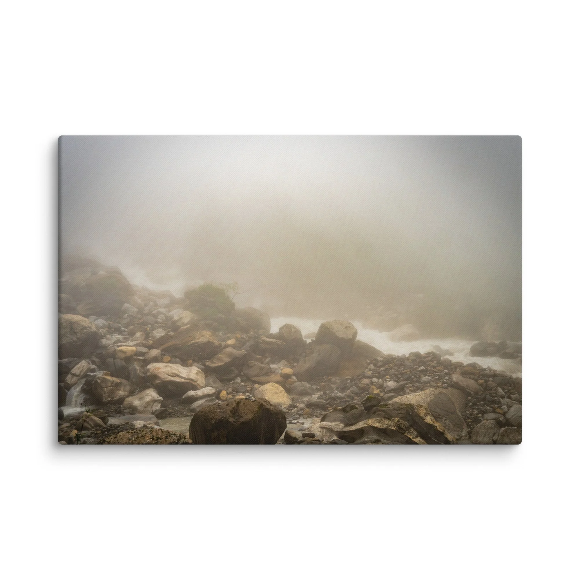 Misty glacial river valley with rounded boulders and gentle rapids on the Annapurna Circuit/Base Camp Trek, Nepal, shrouded in thick fog – high-altitude trekking travel photography