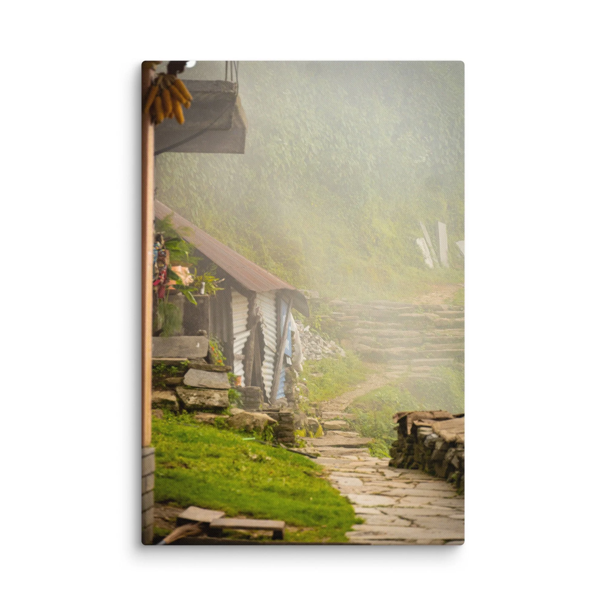 Misty stone village pathway with traditional wooden houses, banana bunches and lush green slopes on the Annapurna Circuit/Base Camp Trek, Nepal – high-altitude trekking travel