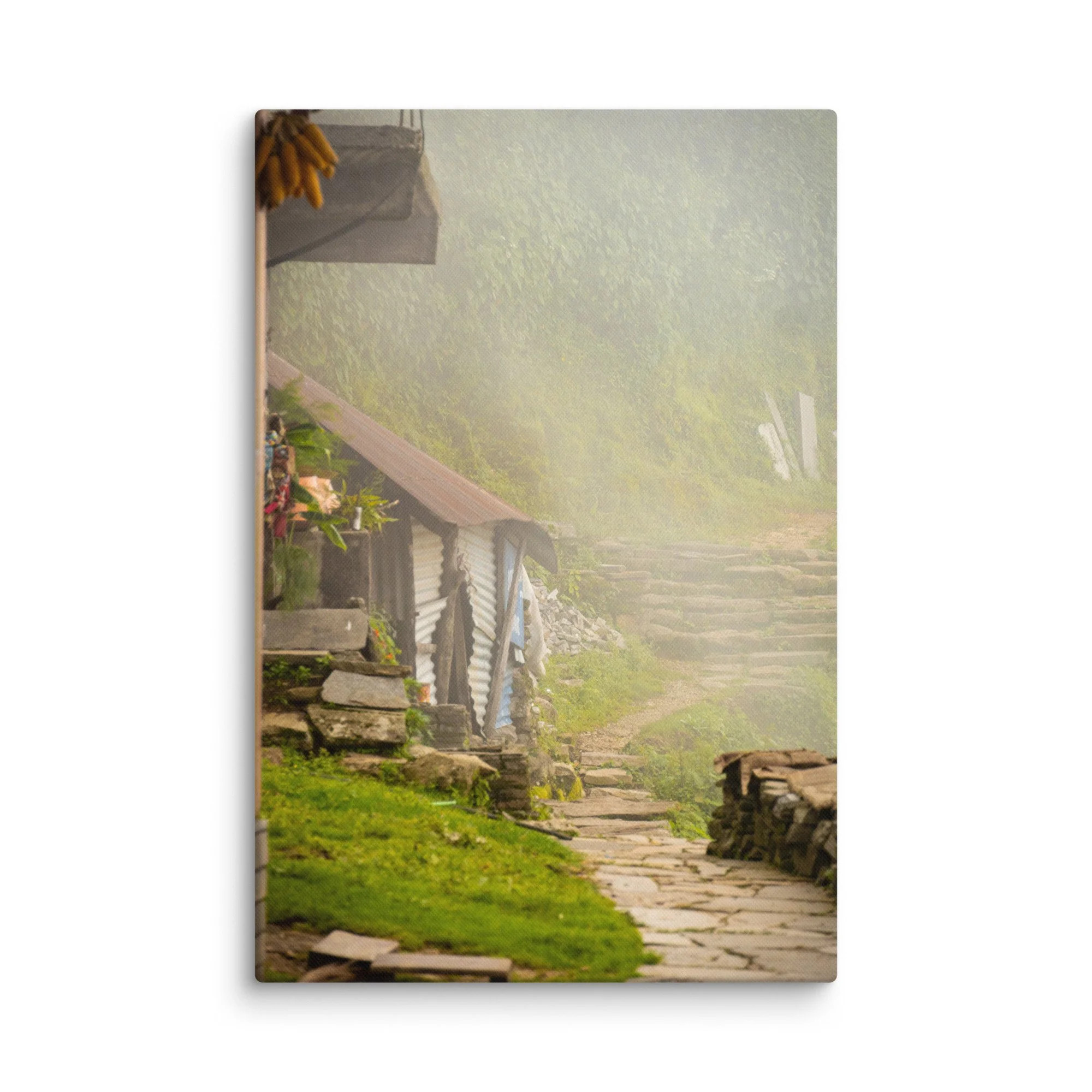 Misty stone village pathway with traditional wooden houses, banana bunches and lush green slopes on the Annapurna Circuit/Base Camp Trek, Nepal – high-altitude trekking travel