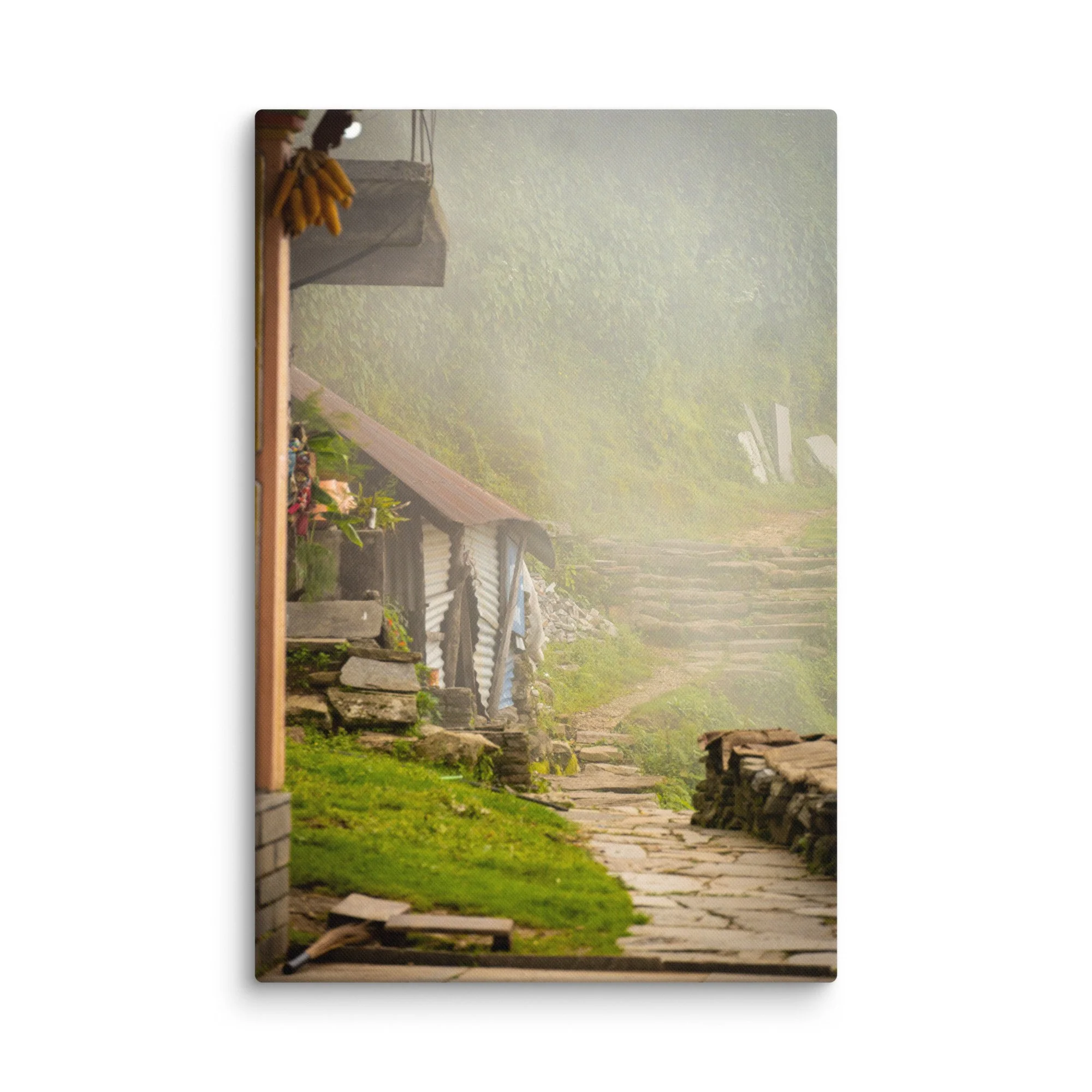 Misty stone village pathway with traditional wooden houses, banana bunches and lush green slopes on the Annapurna Circuit/Base Camp Trek, Nepal – high-altitude trekking travel
