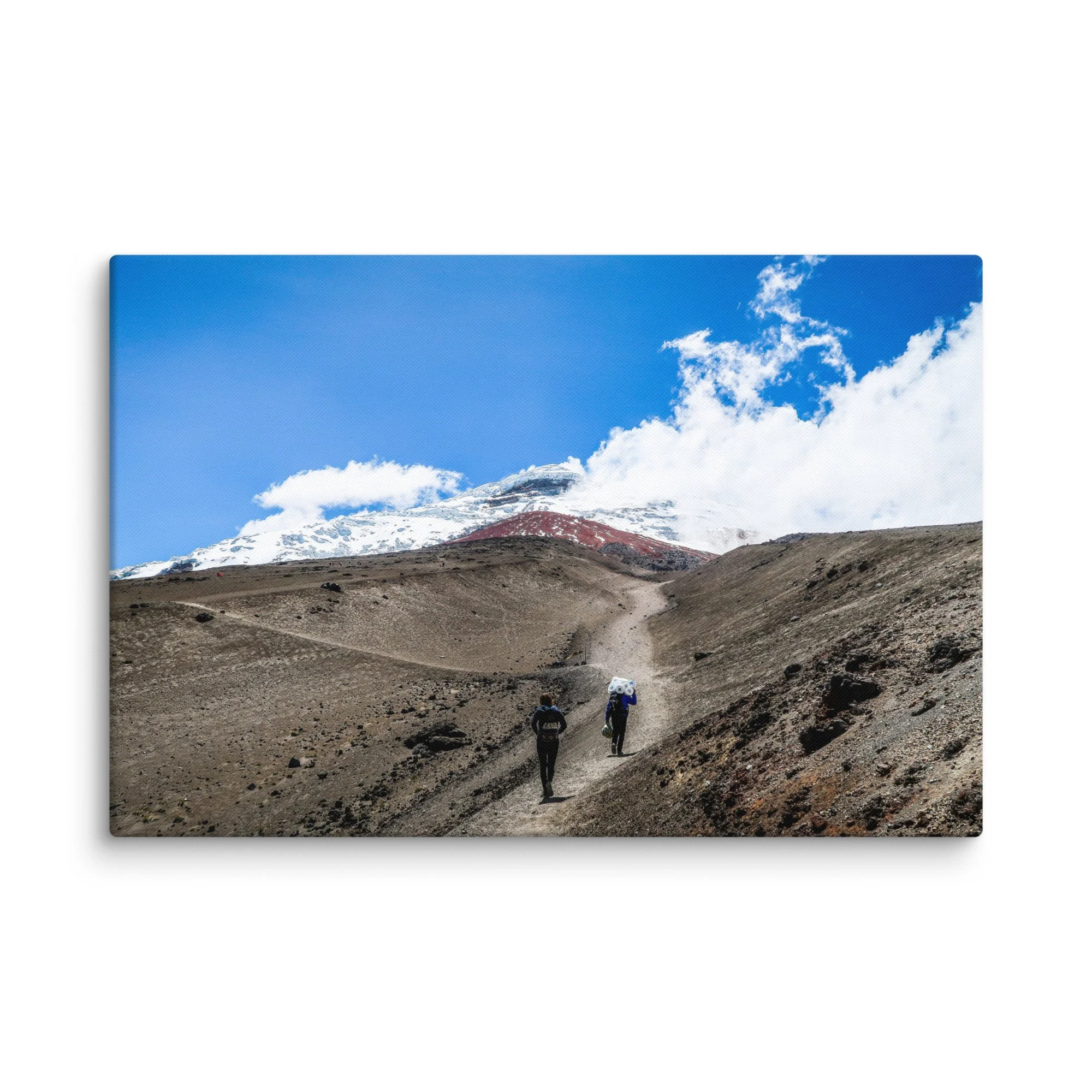Trekkers with backpacks ascending rugged volcanic trail toward snow-capped Cotopaxi summit under blue sky, Ecuador – high-altitude Andes trekking travel photography canvas print