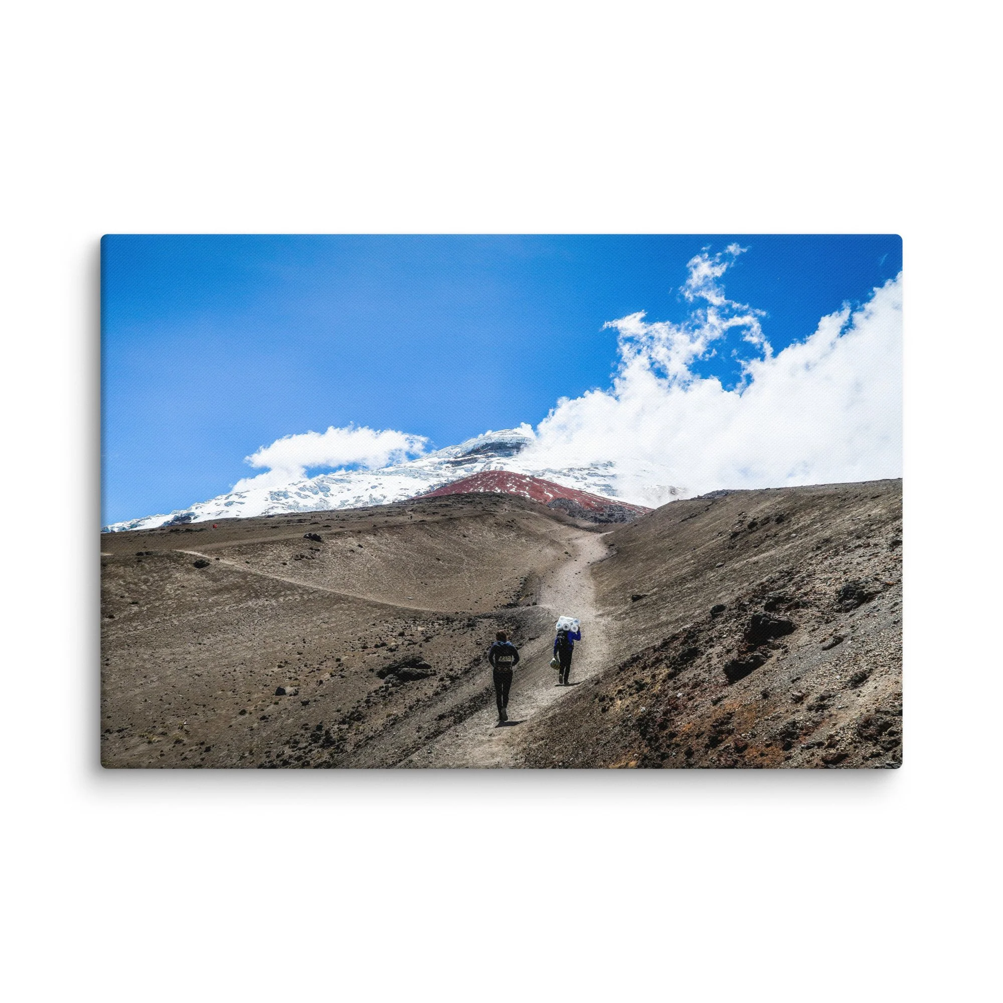 Trekkers with backpacks ascending rugged volcanic trail toward snow-capped Cotopaxi summit under blue sky, Ecuador – high-altitude Andes trekking travel photography canvas print