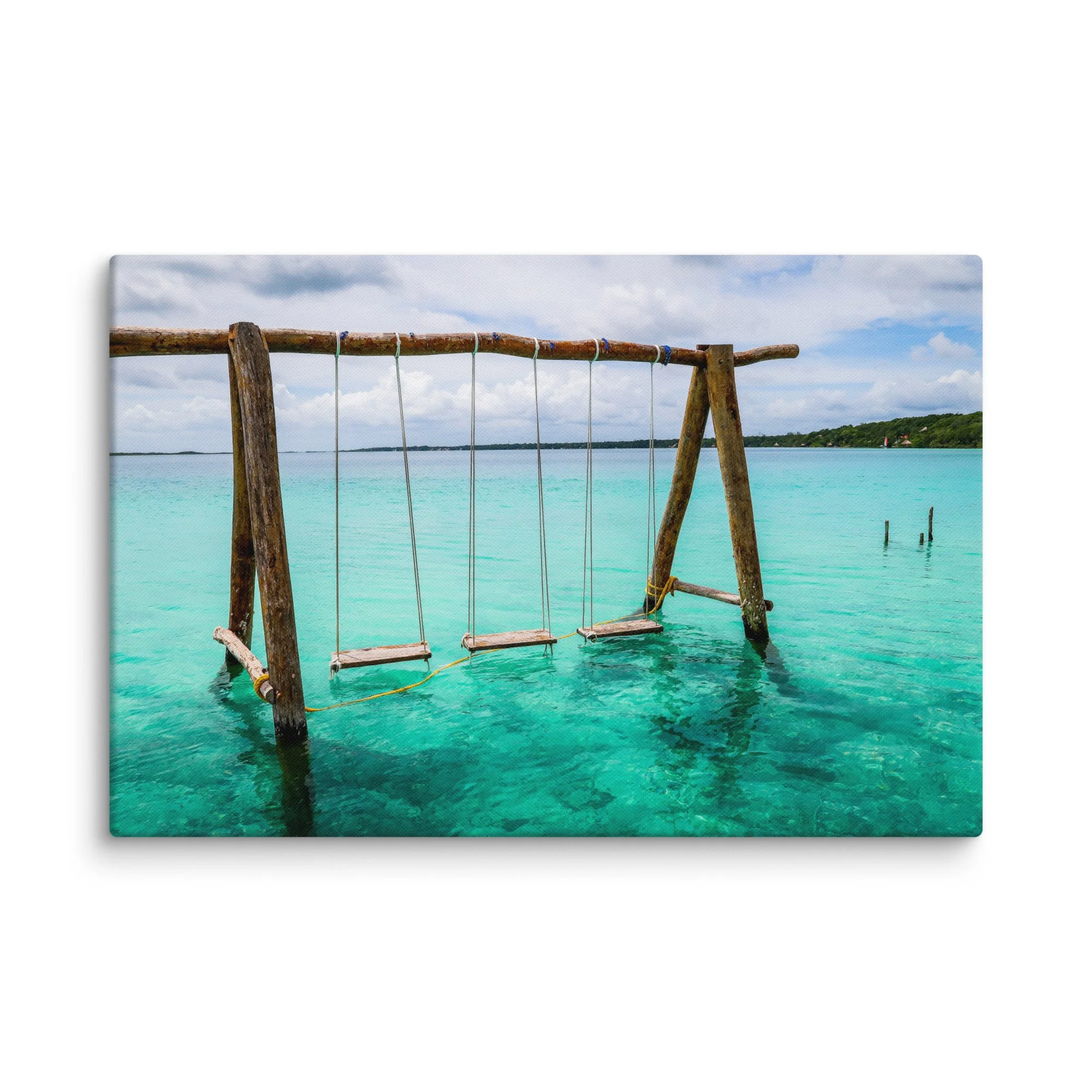 Rustic wooden swing suspended over vibrant turquoise waters of Laguna de Bacalar (Lake of Seven Colors), Mexico, with tropical jungle and distant hills – serene tropical travel photography