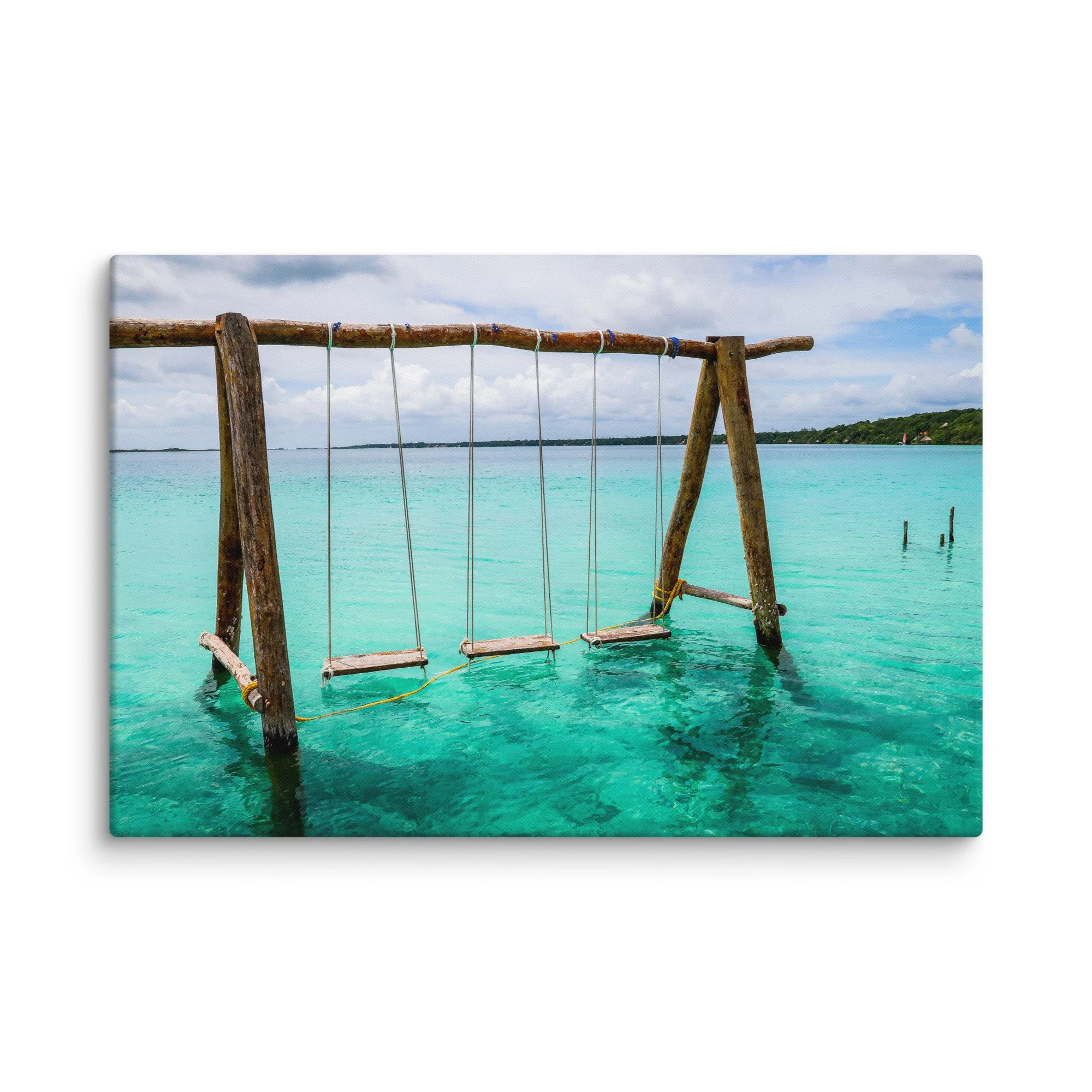 Rustic wooden swing suspended over vibrant turquoise waters of Laguna de Bacalar (Lake of Seven Colors), Mexico, with tropical jungle and distant hills – serene tropical travel photography