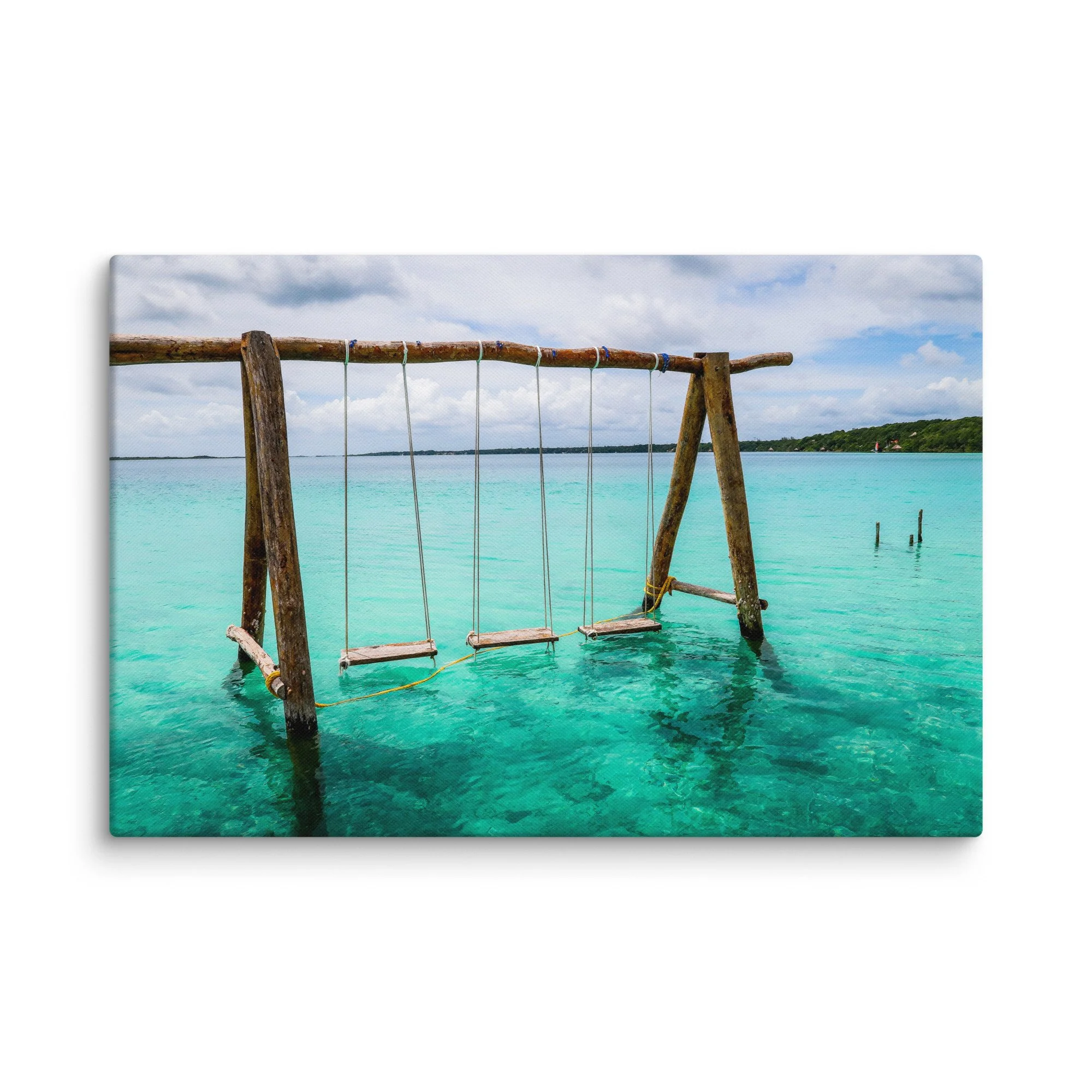 Rustic wooden swing suspended over vibrant turquoise waters of Laguna de Bacalar (Lake of Seven Colors), Mexico, with tropical jungle and distant hills – serene tropical travel photography