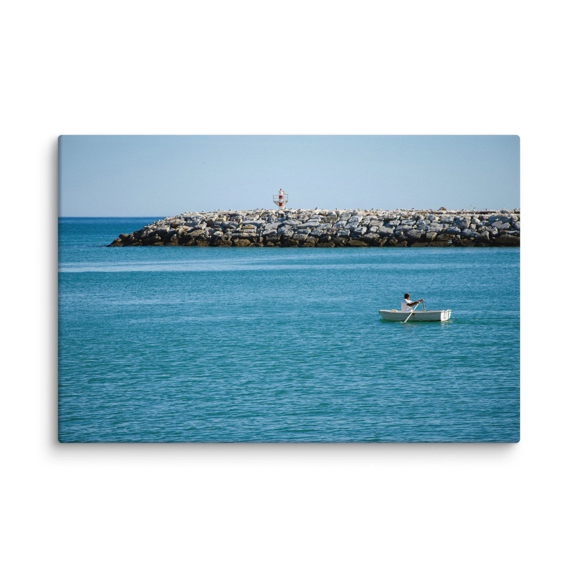 Fisherman rowing a white boat toward a red-and-white lighthouse on a stone breakwater with seabirds, turquoise Atlantic waters, Ireland – Celtic coastal travel photography canvas print