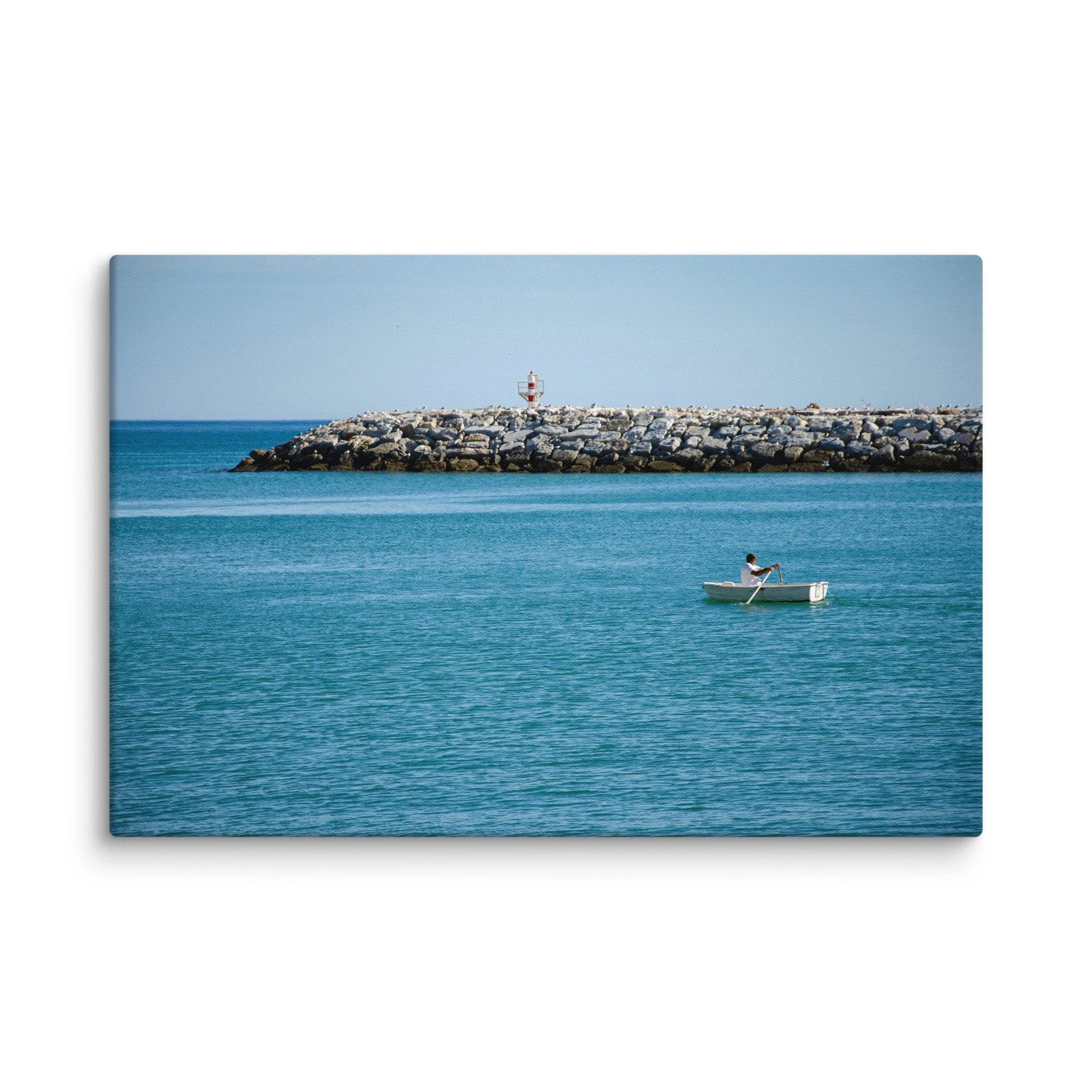Fisherman rowing a white boat toward a red-and-white lighthouse on a stone breakwater with seabirds, turquoise Atlantic waters, Ireland – Celtic coastal travel photography canvas print