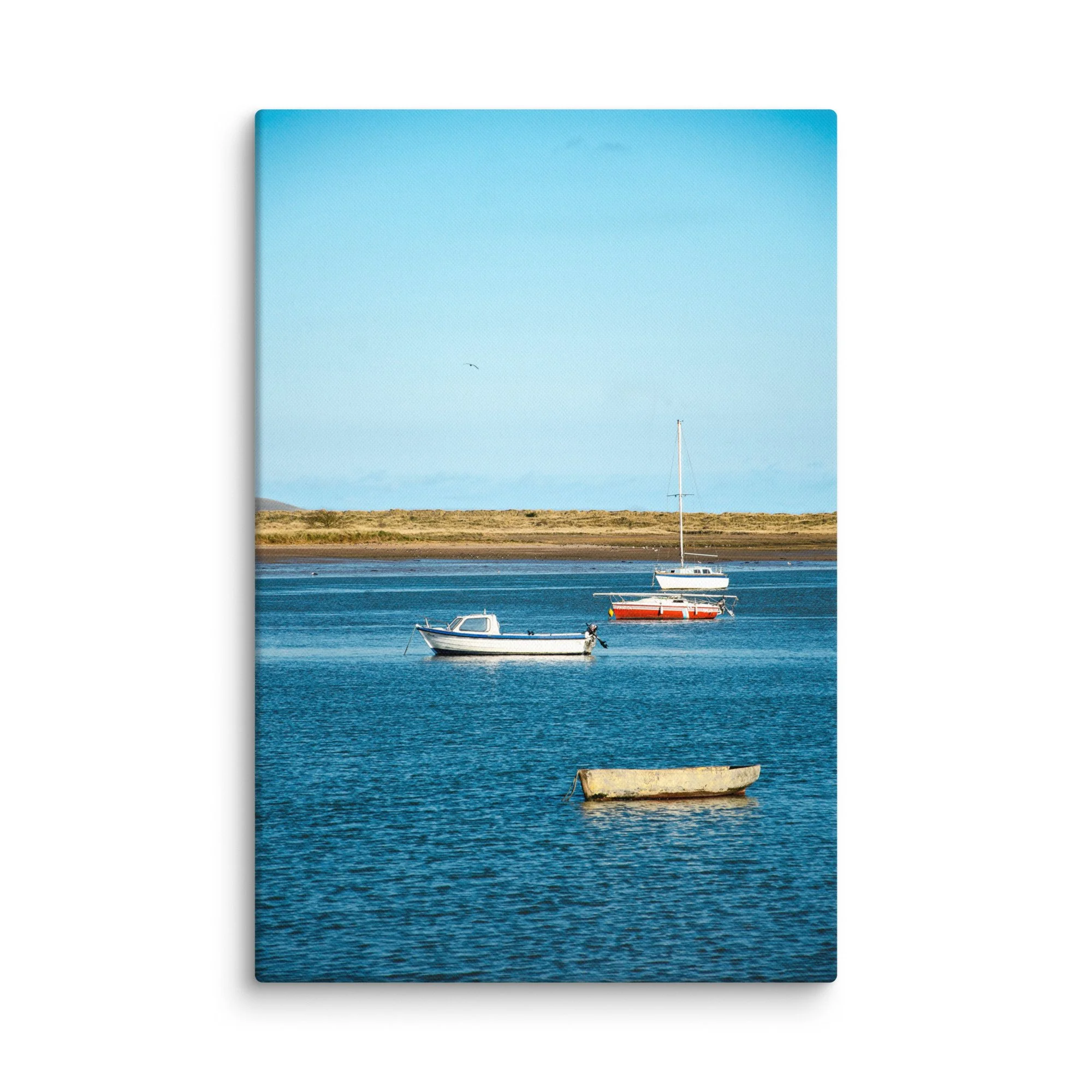 Traditional fishing boats moored in calm blue tidal waters with golden marram grass dunes and distant hills, Ireland – coastal travel photography canvas print wall art decor
