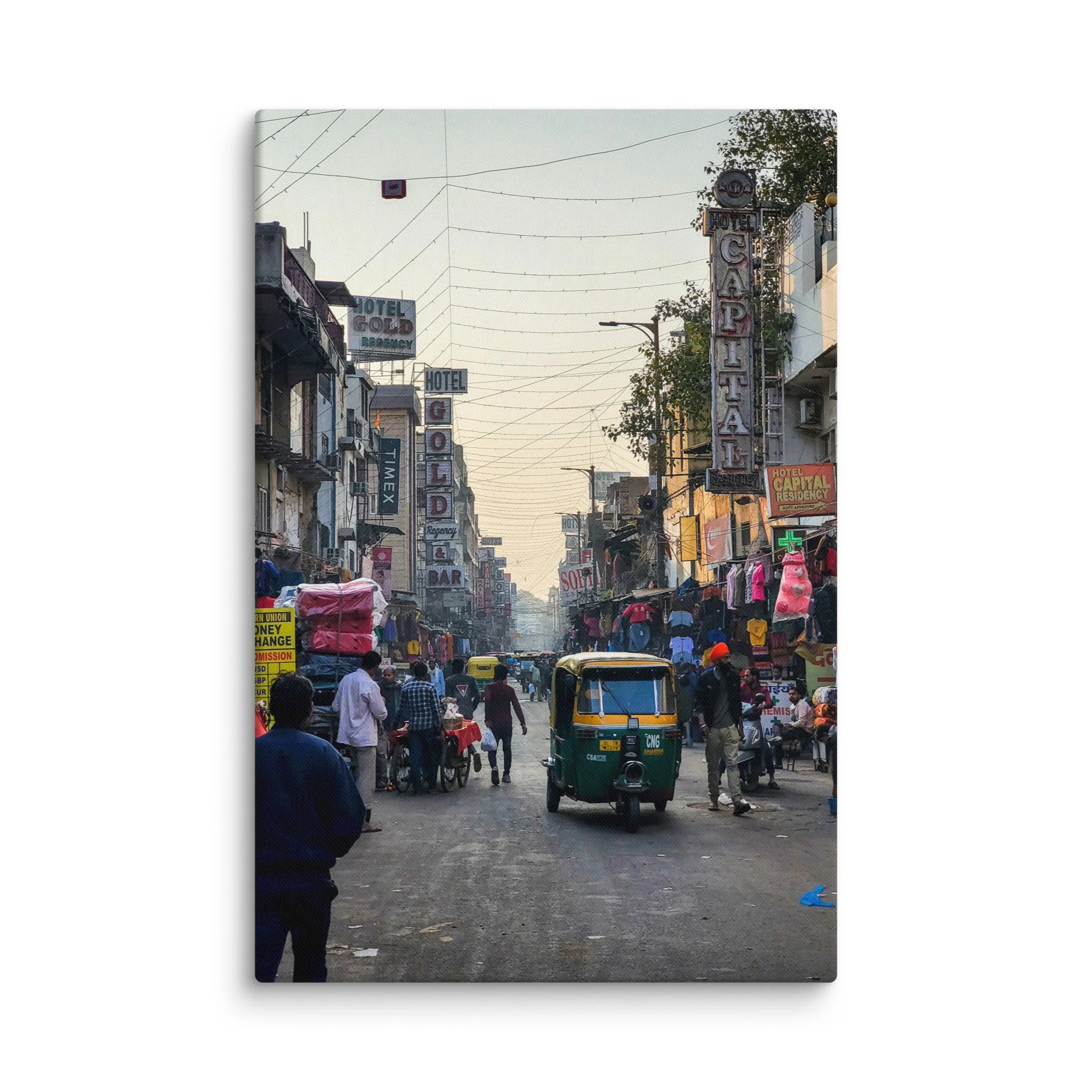 Bustling Paharganj alley in Delhi, India, with colorful auto-rickshaws, neon hotel signs, tangled wires and crowds at golden hour – vibrant street travel photography canvas print wall art