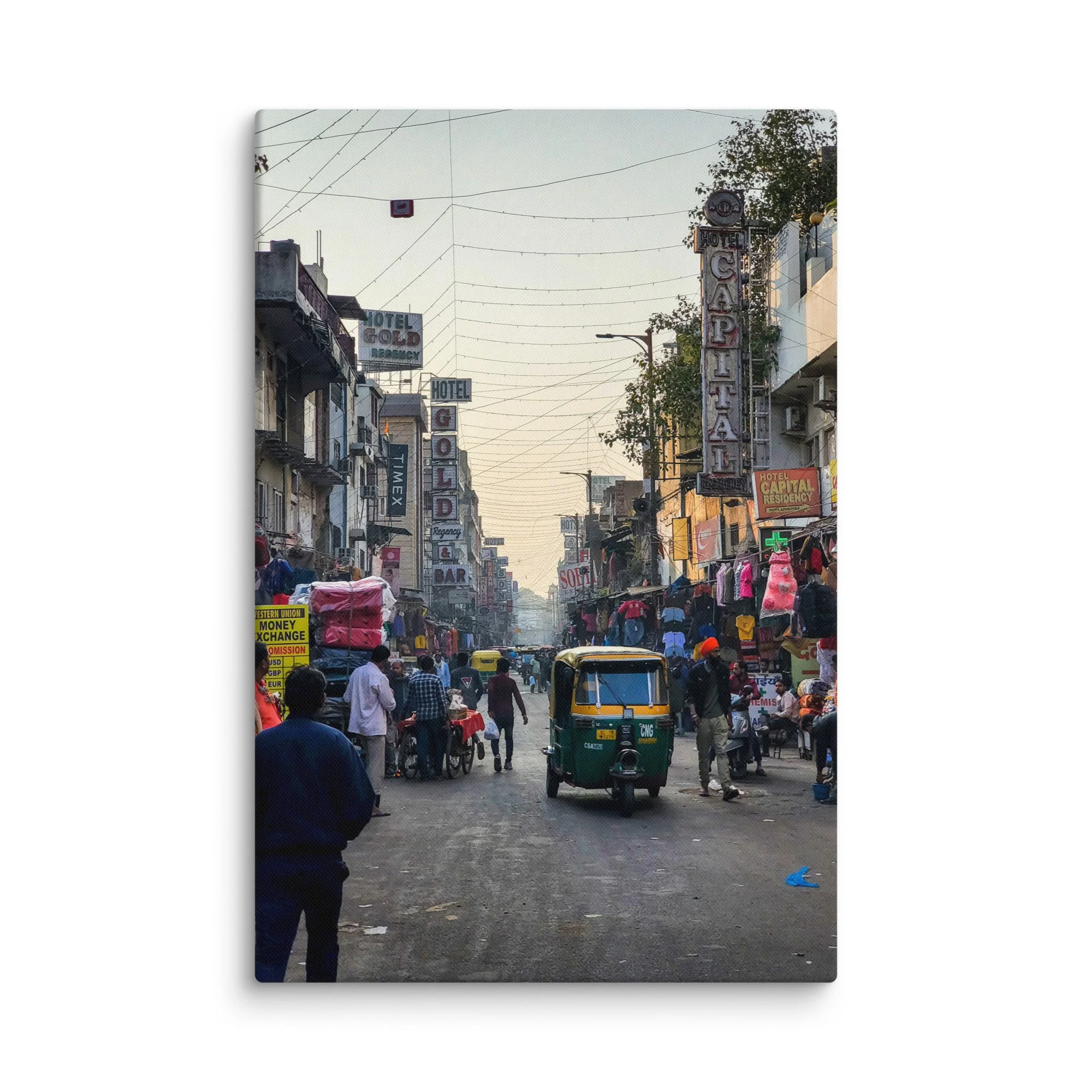 Bustling Paharganj alley in Delhi, India, with colorful auto-rickshaws, neon hotel signs, tangled wires and crowds at golden hour – vibrant street travel photography canvas print wall art