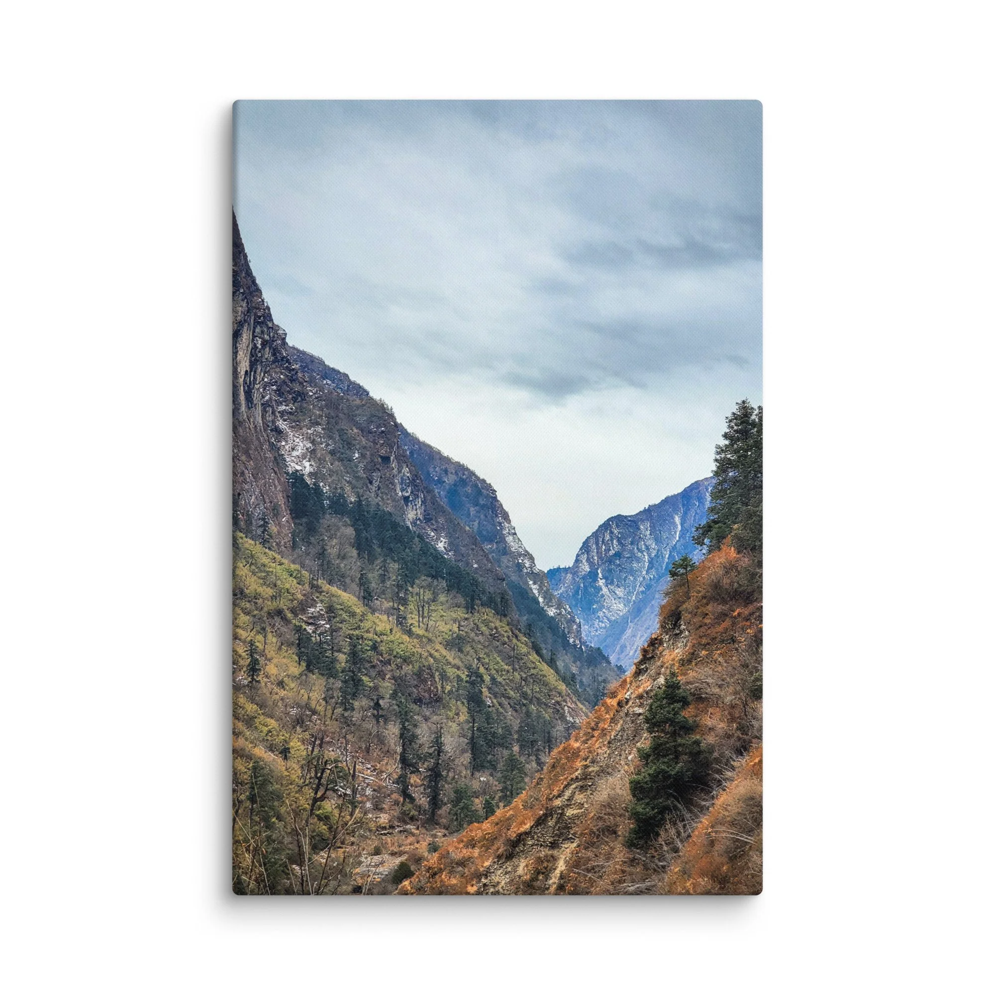 Dramatic deep gorge in Langtang Valley with towering snow-capped peaks, pine forests and rocky riverbed under blue sky, Nepal – Himalayan trekking travel photography canvas print