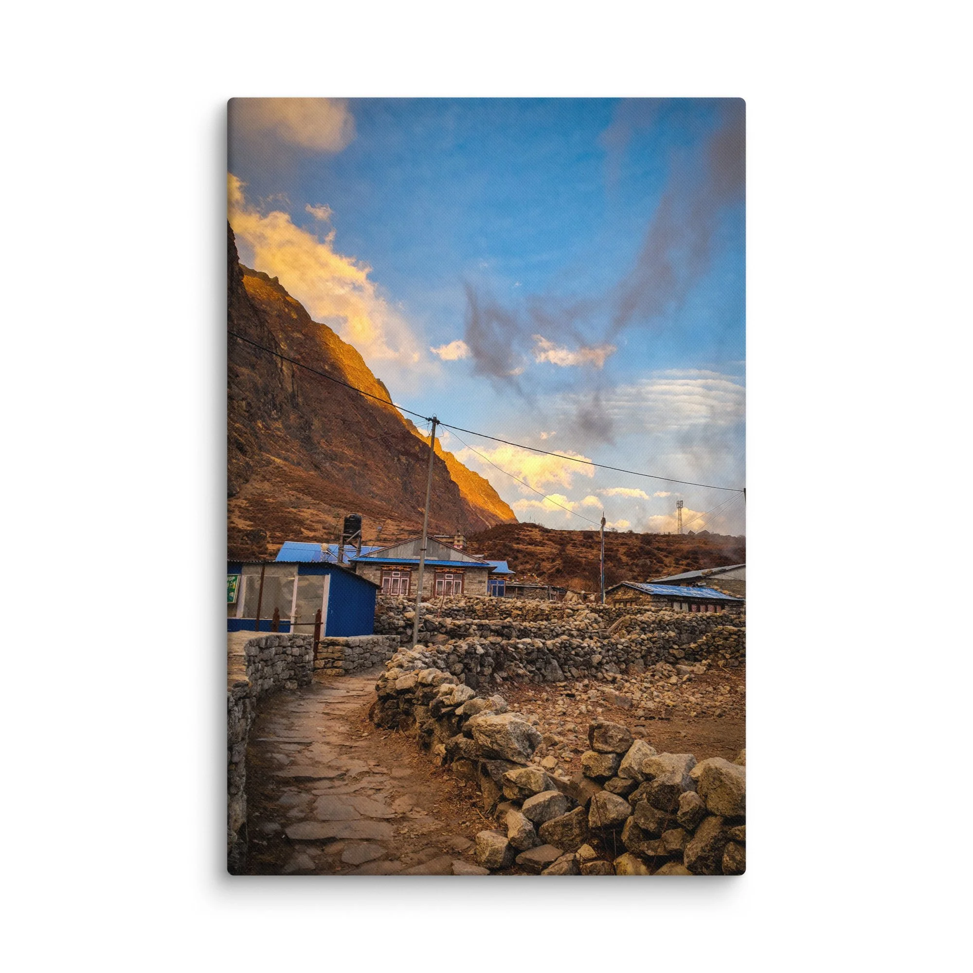 Traditional stone teahouses and lodges in Langtang Valley village at golden sunset, with dramatic snow-capped peaks and misty mountains, Nepal – Himalayan trekking travel photography