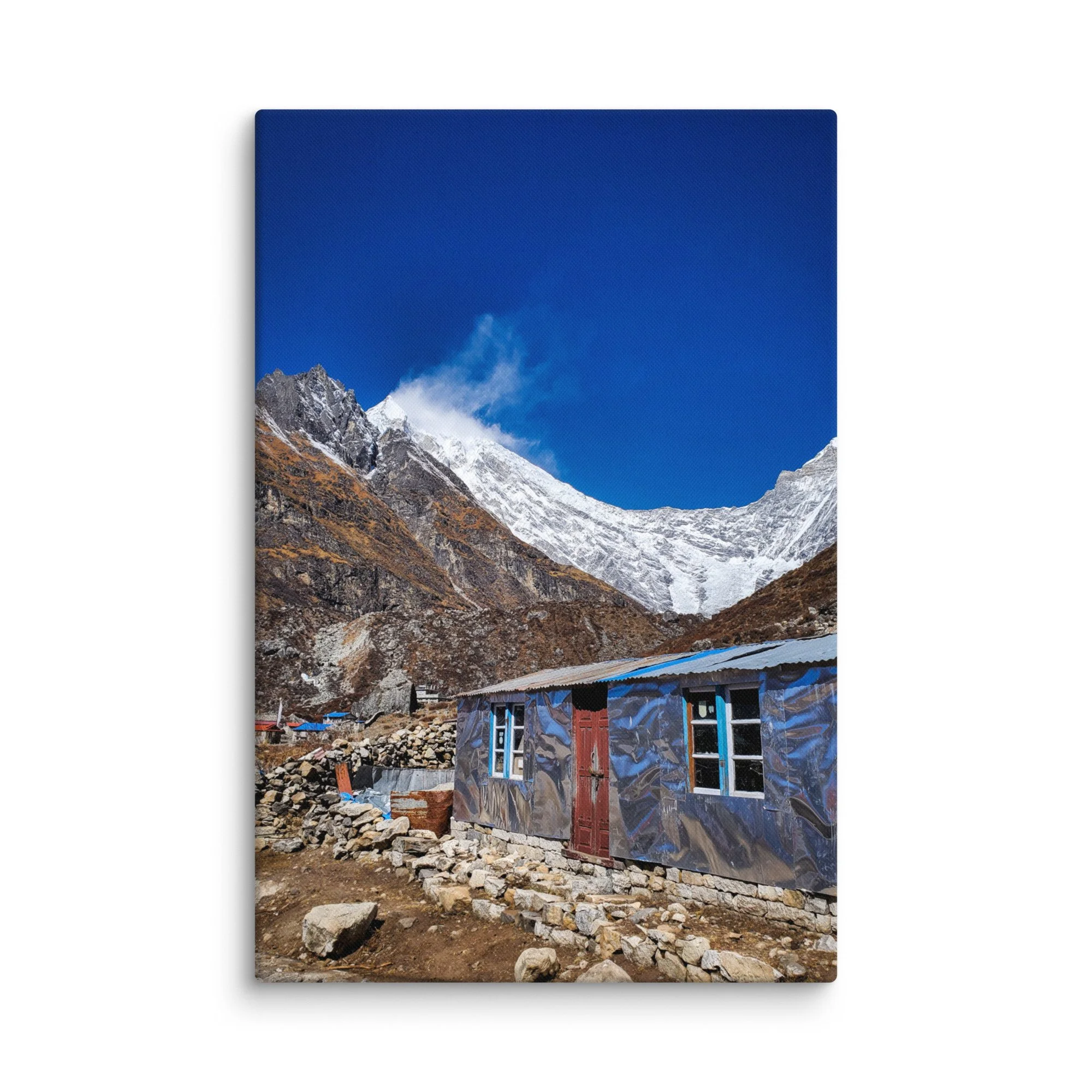 Traditional stone teahouses and lodges in Langtang Valley village at golden sunset, with dramatic snow-capped peaks and misty mountains, Nepal – Himalayan trekking travel photography
