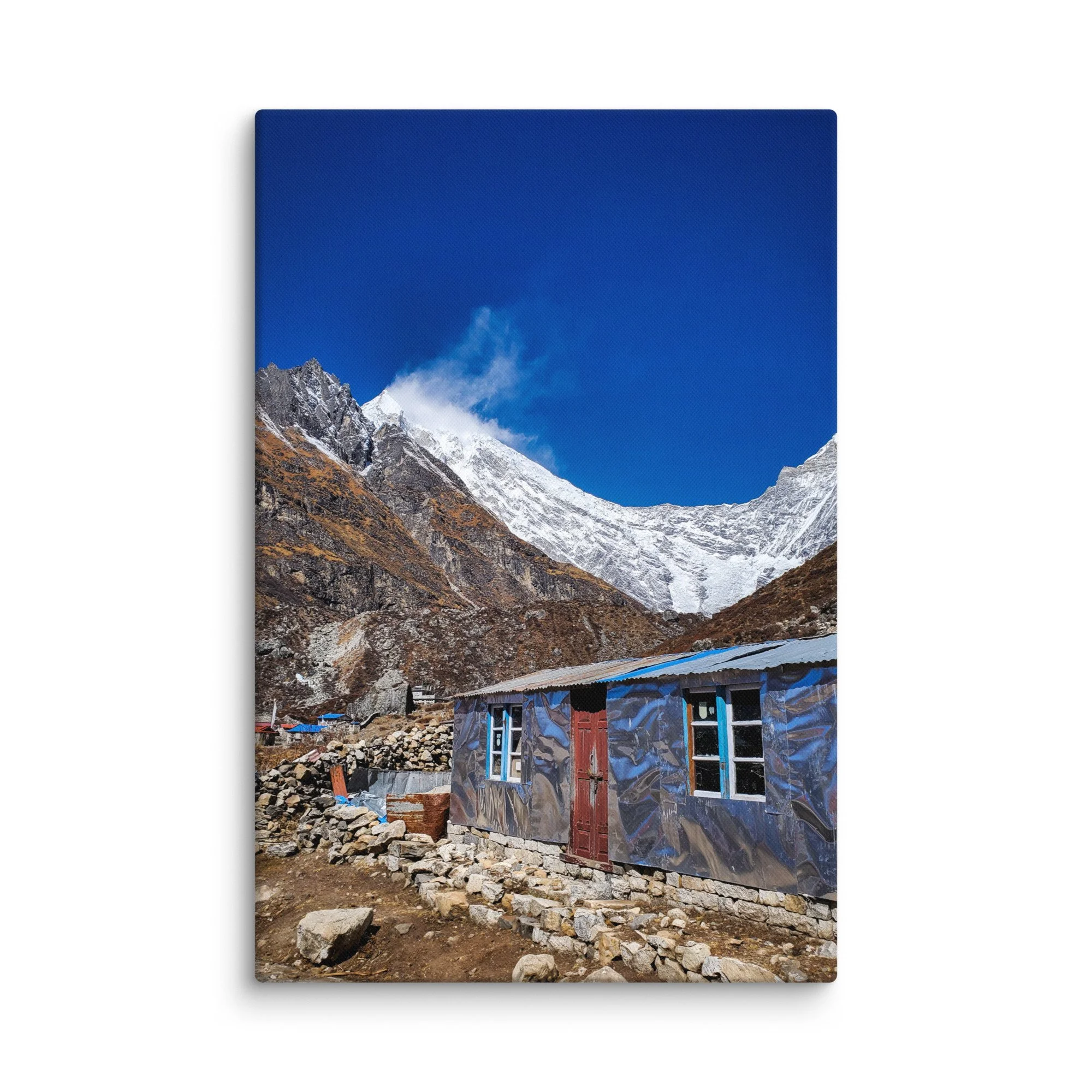 Traditional stone teahouses and lodges in Langtang Valley village at golden sunset, with dramatic snow-capped peaks and misty mountains, Nepal – Himalayan trekking travel photography
