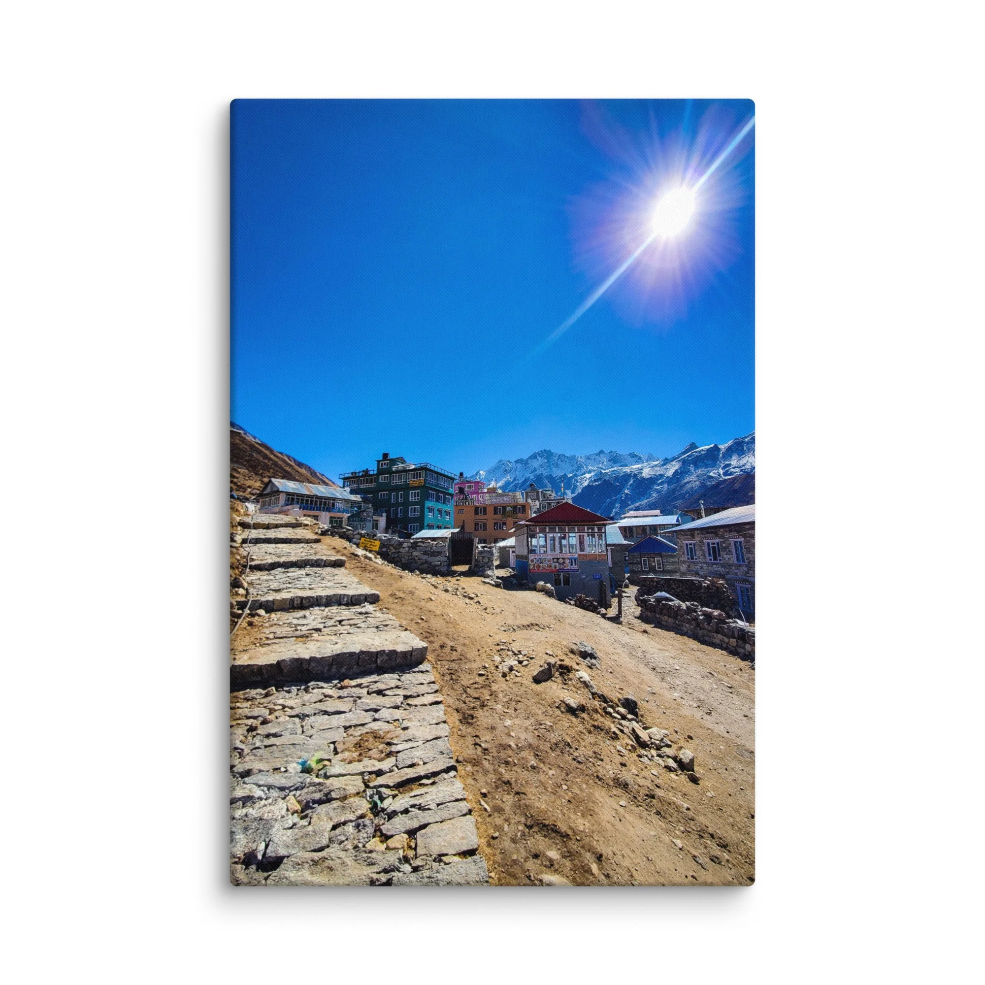 Colorful tin-roofed teahouses and stone lodges in Kyanjin Gompa village, Langtang Valley, Nepal, under brilliant blue sky with majestic snow-capped peaks – Himalayan trekking travel