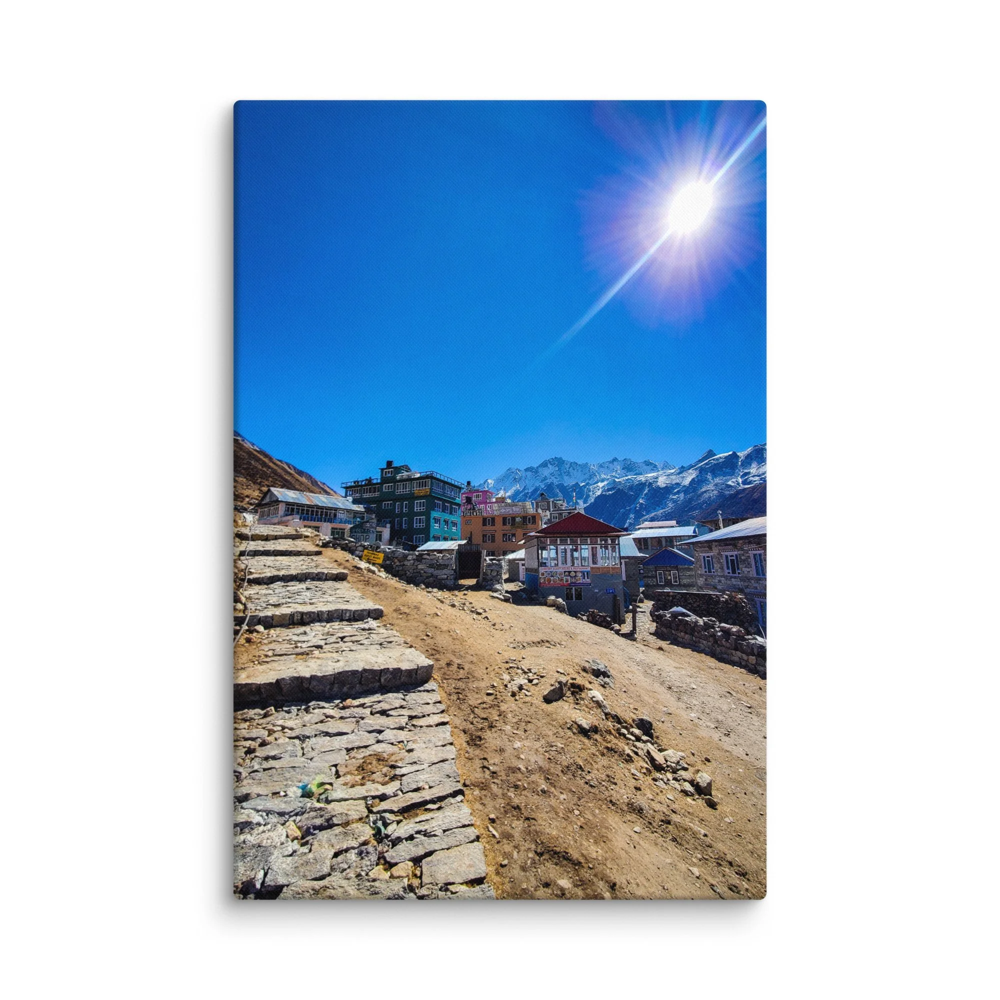 Colorful tin-roofed teahouses and stone lodges in Kyanjin Gompa village, Langtang Valley, Nepal, under brilliant blue sky with majestic snow-capped peaks – Himalayan trekking travel
