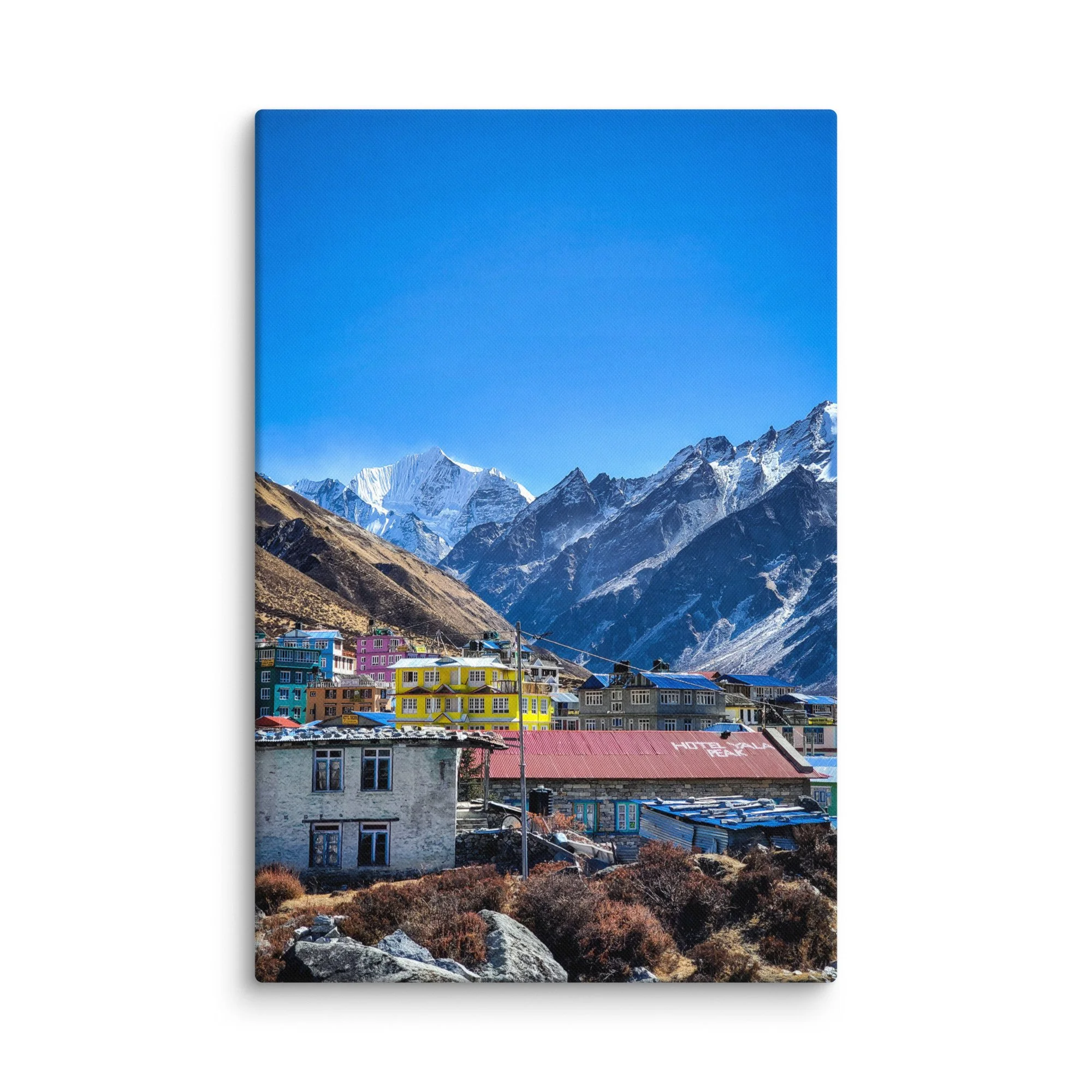 Colorful tin-roofed teahouses and stone lodges in Kyanjin Gompa village, Langtang Valley, Nepal, under brilliant blue sky with majestic snow-capped peaks – Himalayan trekking travel