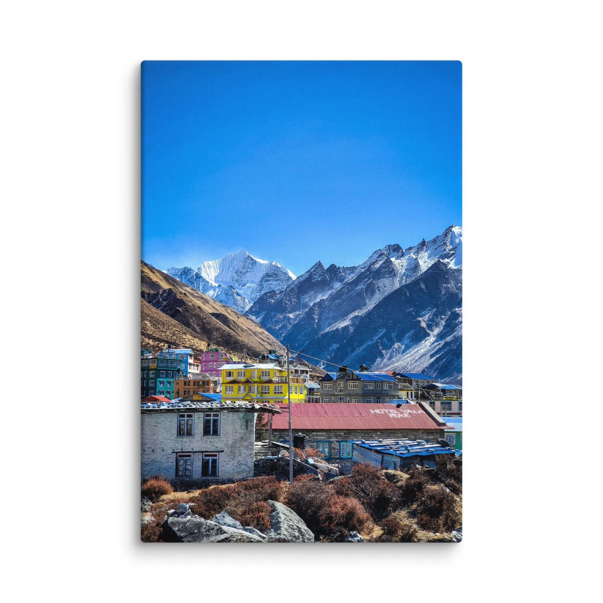 Colorful tin-roofed teahouses and stone lodges in Kyanjin Gompa village, Langtang Valley, Nepal, under brilliant blue sky with majestic snow-capped peaks – Himalayan trekking travel
