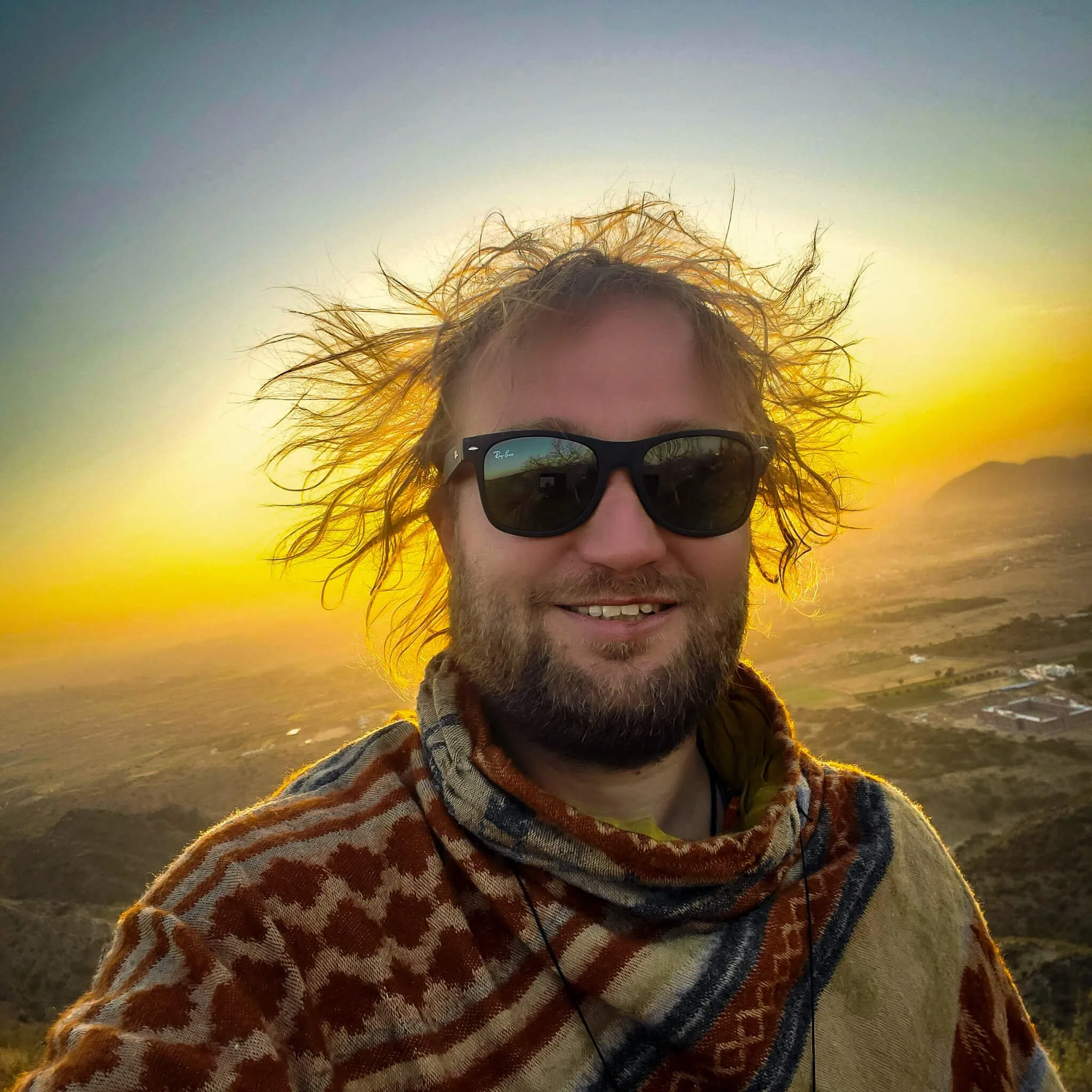 artist jadoo with a sunset and golden sun light aura around him tels his story of becoming artist