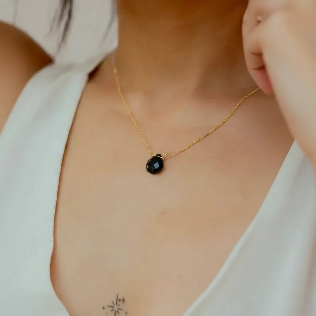 onyx on gold chain.webp