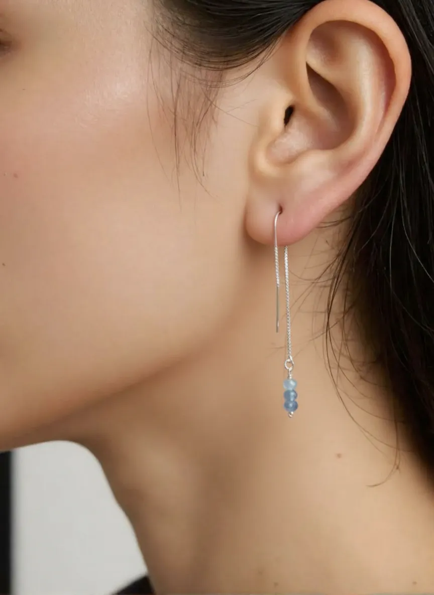 silver iris earring on model.png