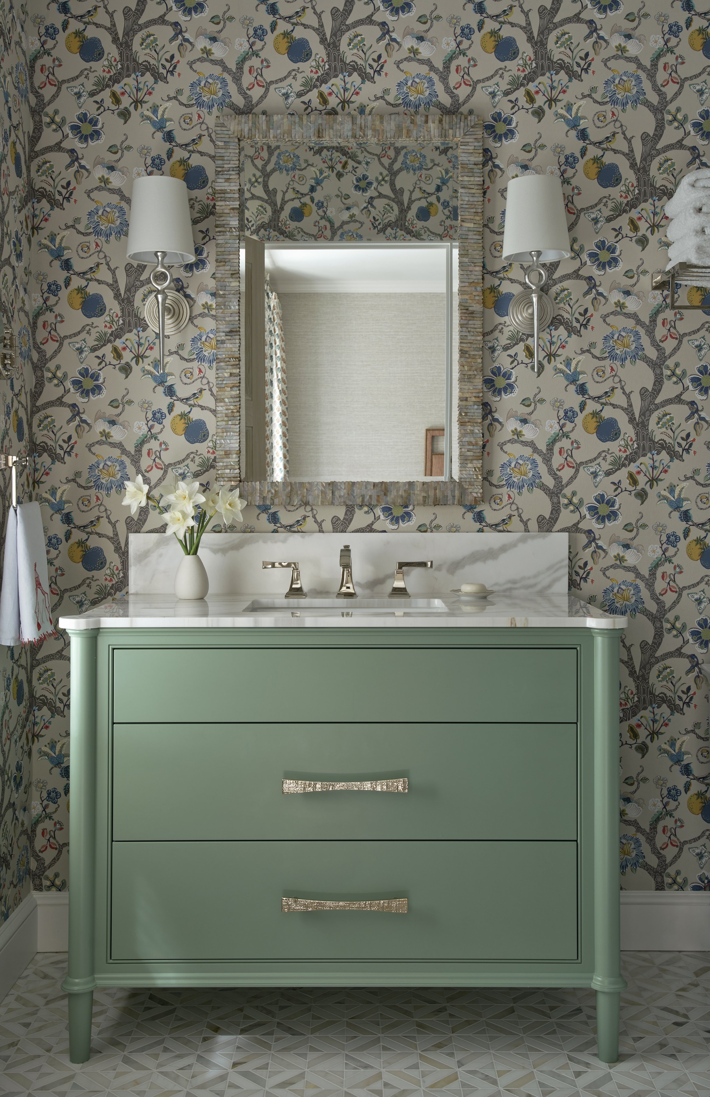 bathroom design with mint green vanity marble countertop floral wallpaper silver fixtures geometric tiled floor modern home décor