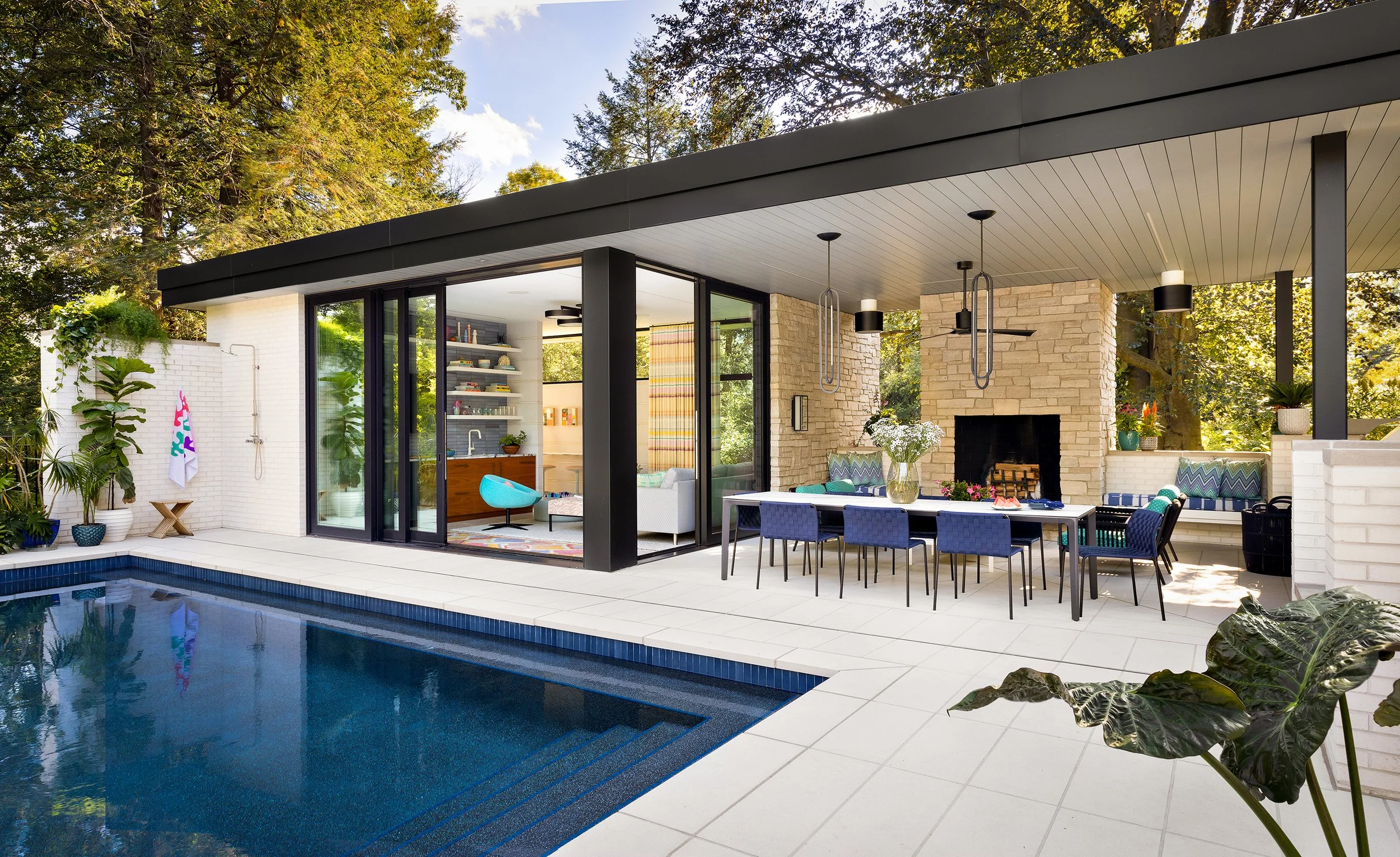modern house pool design with outdoor dining fireplace and comfortable seating area
