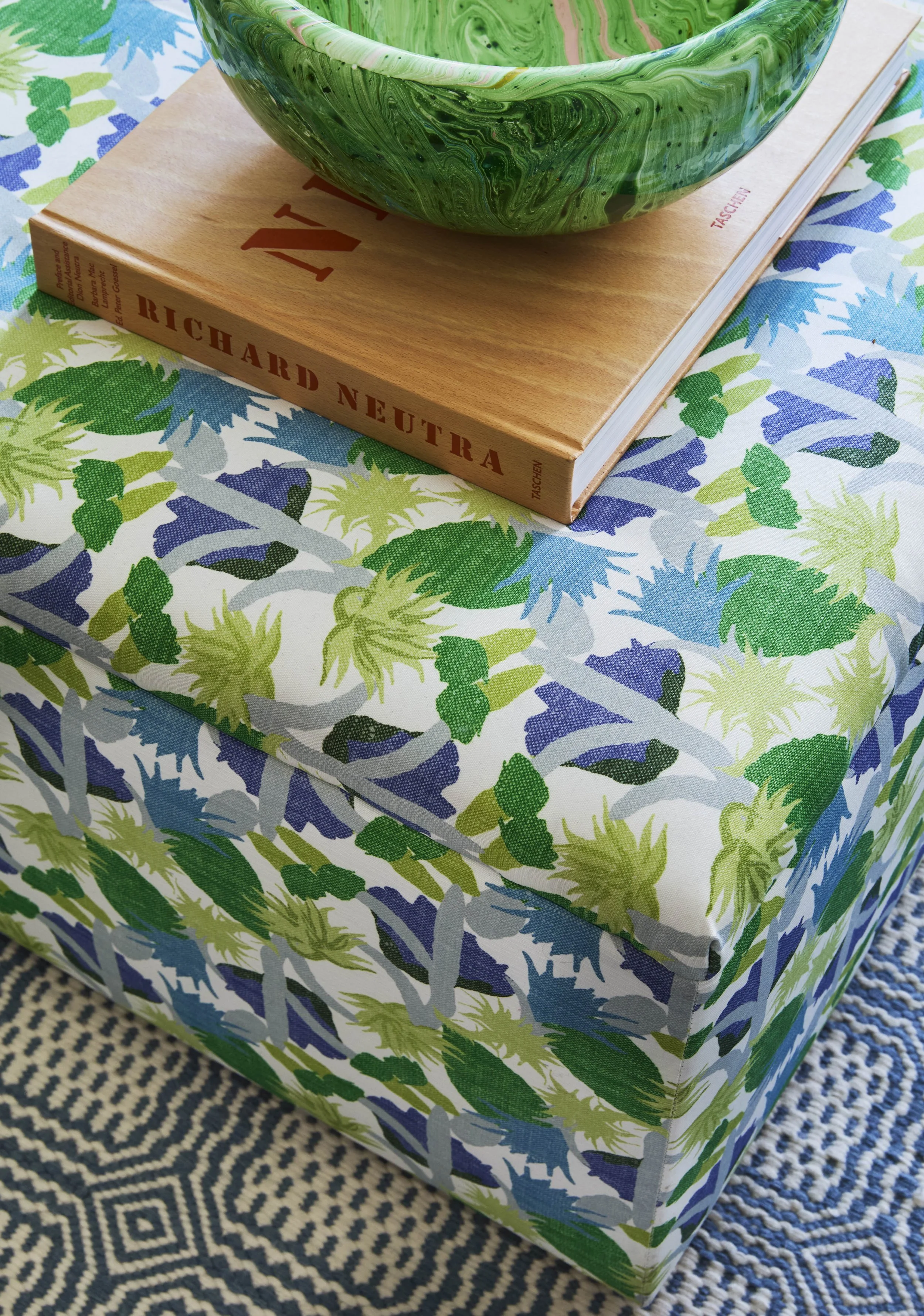 custom fabric ottoman in blue and green print. 