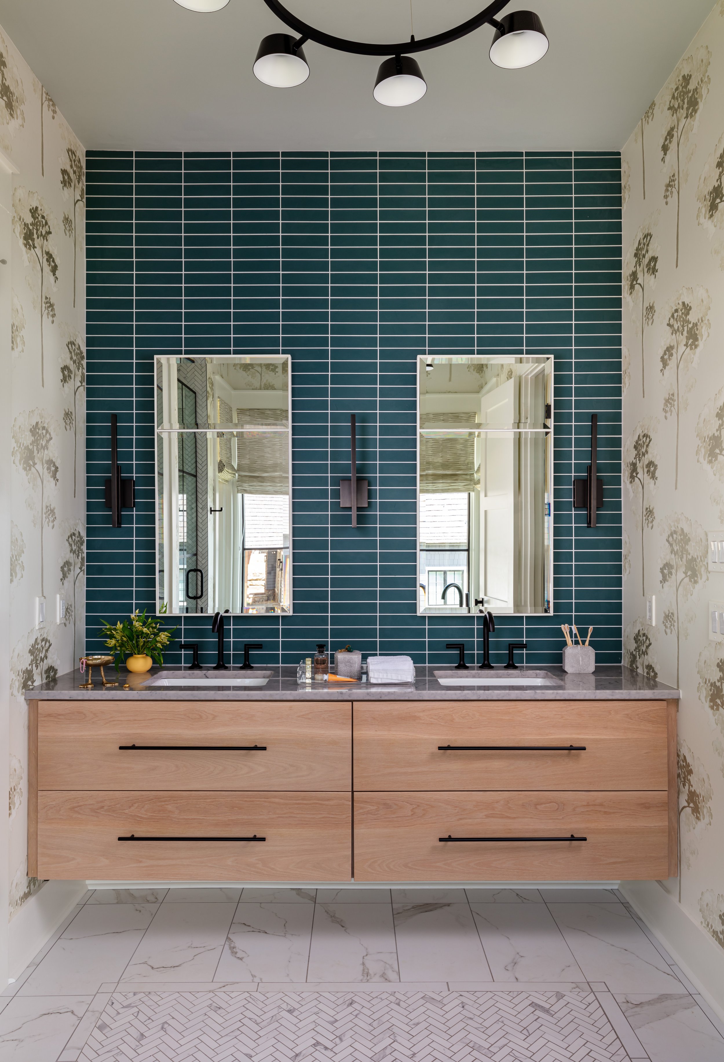 Stylish double‑sink vanity bathroom with teal tile accent wall, black fixtures, marble countertop, and modern light fixture for chic interior design inspiration
