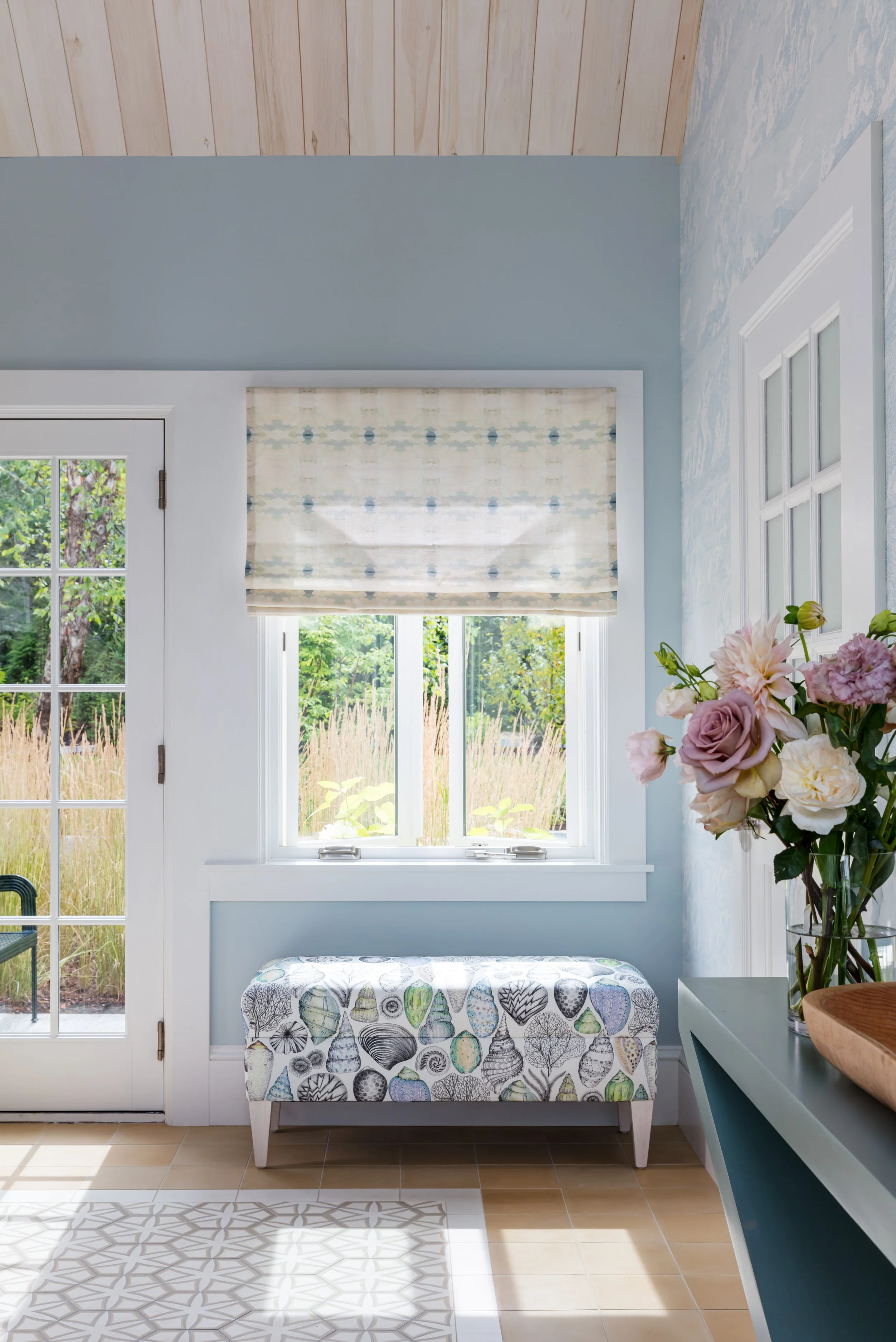 soft-blue-bedroom-nook-with-floral-bench-and-roman-shade.jpg