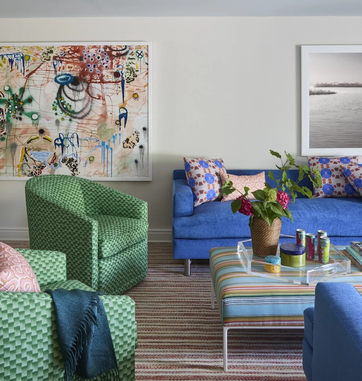eclectic gameroom seating with green geometric armchairs cobalt blue sofa striped ottoman large abstract artwork by betsy wentz design