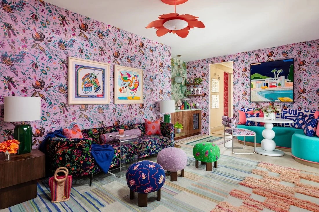 colorful-maximalist-living-room-pink-floral-wallpaper-floral-sofa-embroidered-ottomans-kips-bay.jpg