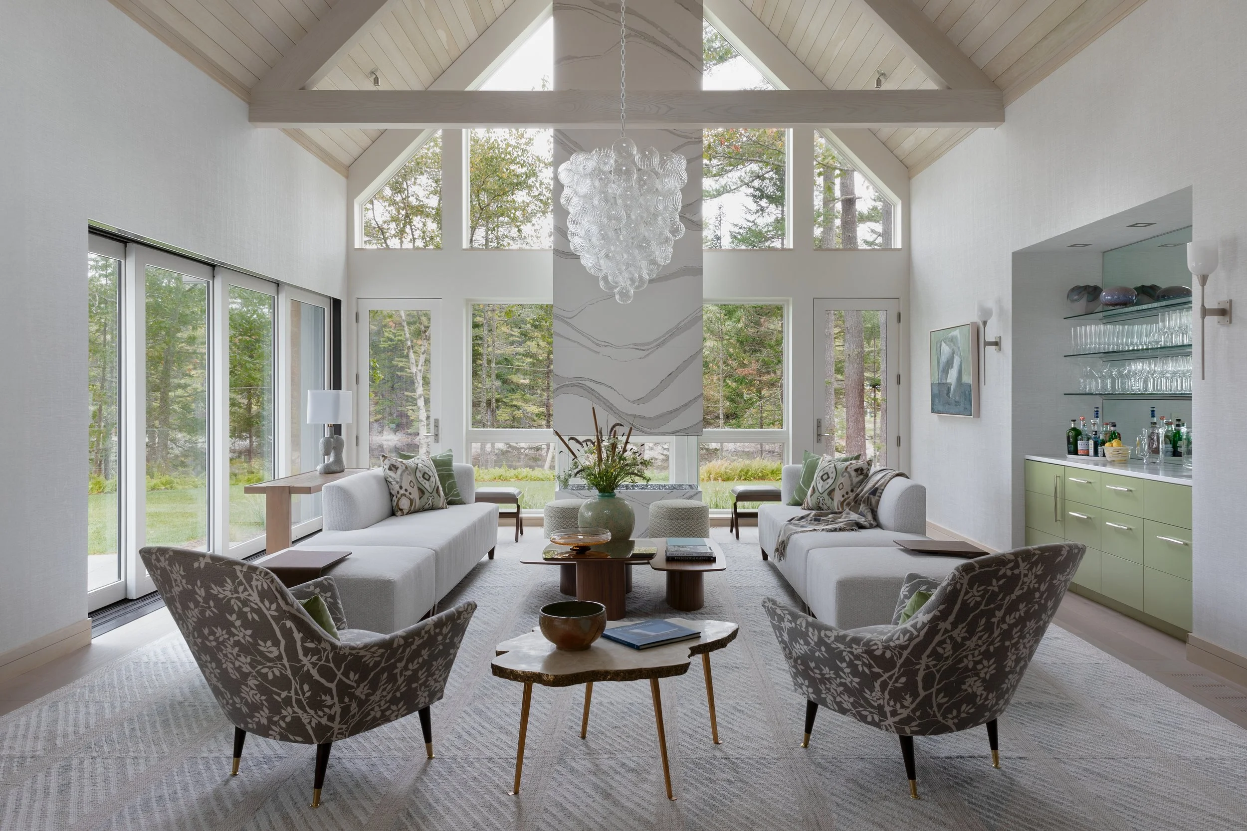 modern-living-room-neutral-tone-sofas-large-floor-to-ceiling-windows.jpg