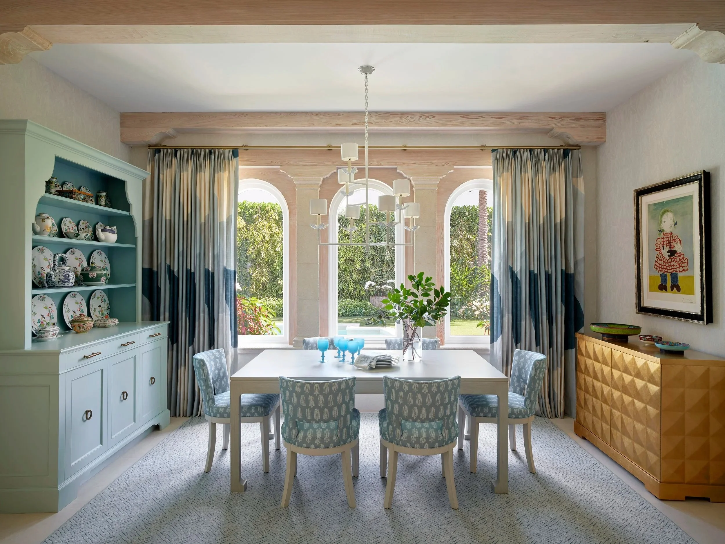 dining room design with mint hutch floral dishes arched windows blue chairs garden view luxury interior decor home inspiration