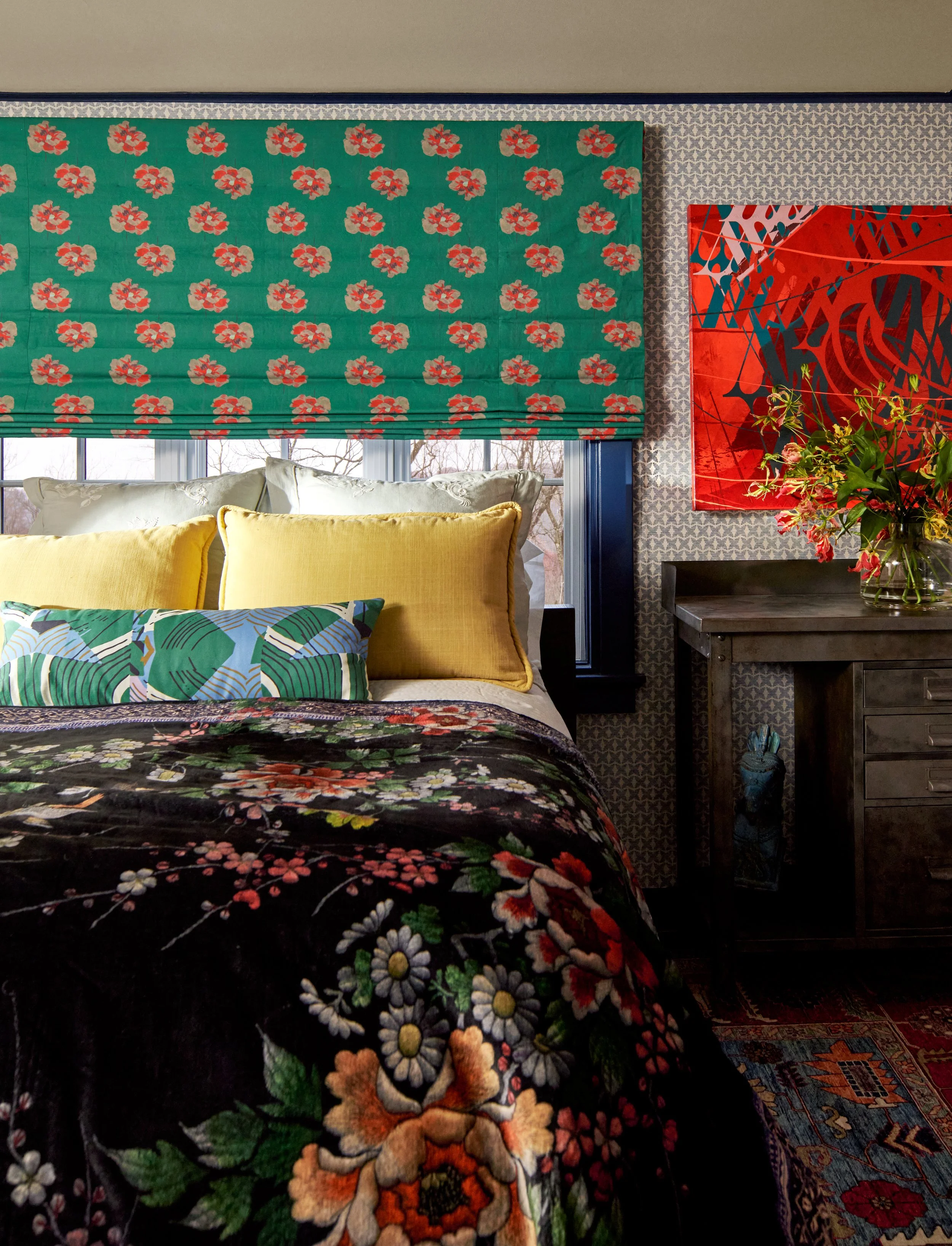Playful and colorful bedroom with floral bedding, custom window treatment and bold wall art. 