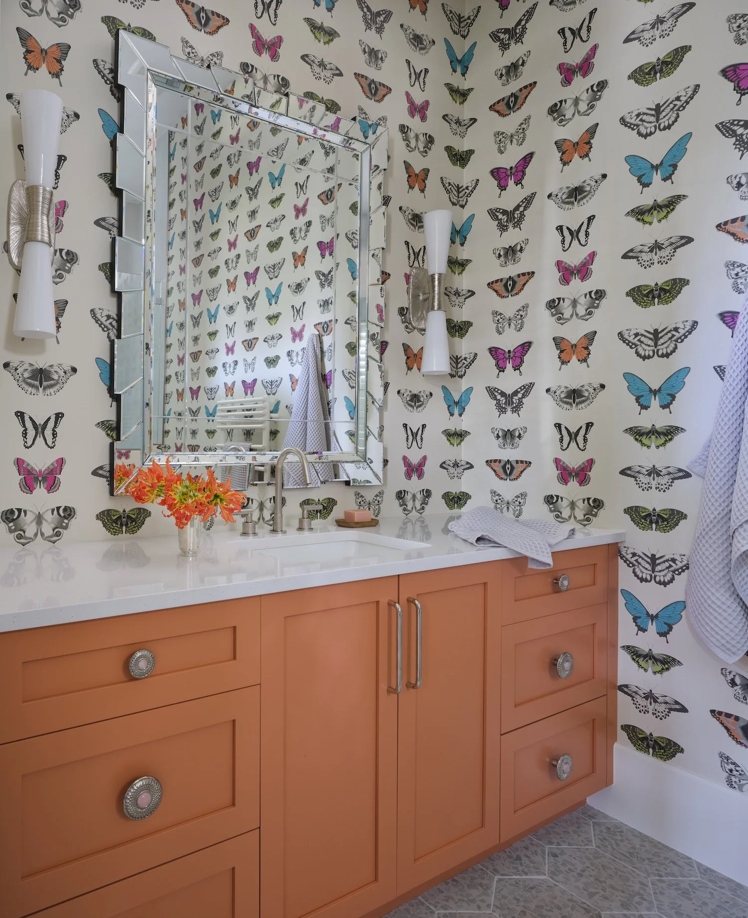 38-butterfly-wallpaper-bathroom-orange-vanity-white-countertop-mirrored-sconces-bold-playful-design.jpg
