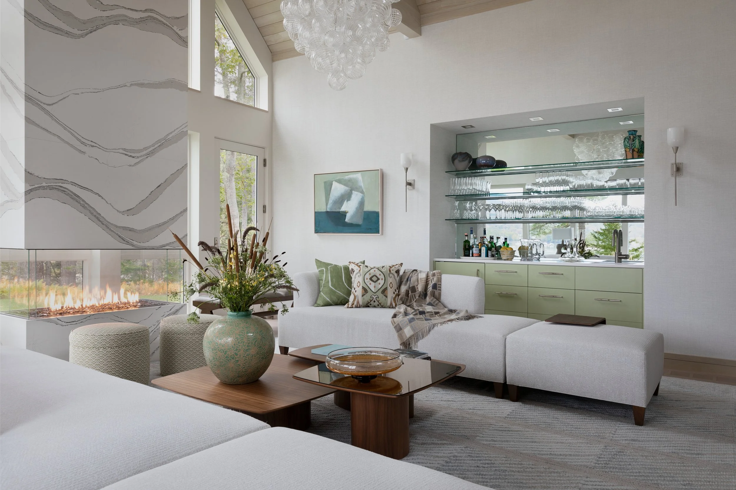 living room modern two sided fireplace with quartz surround and comfortable sofas and coffee table