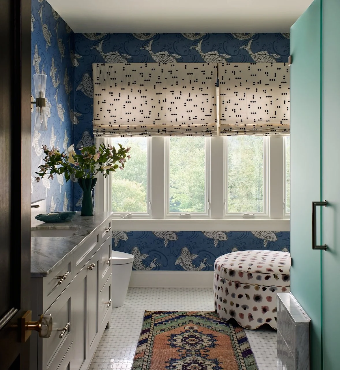Playful bathroom koi wallpaper dotted roman shades marble vanity mosaic floor scalloped ottoman vintage rug