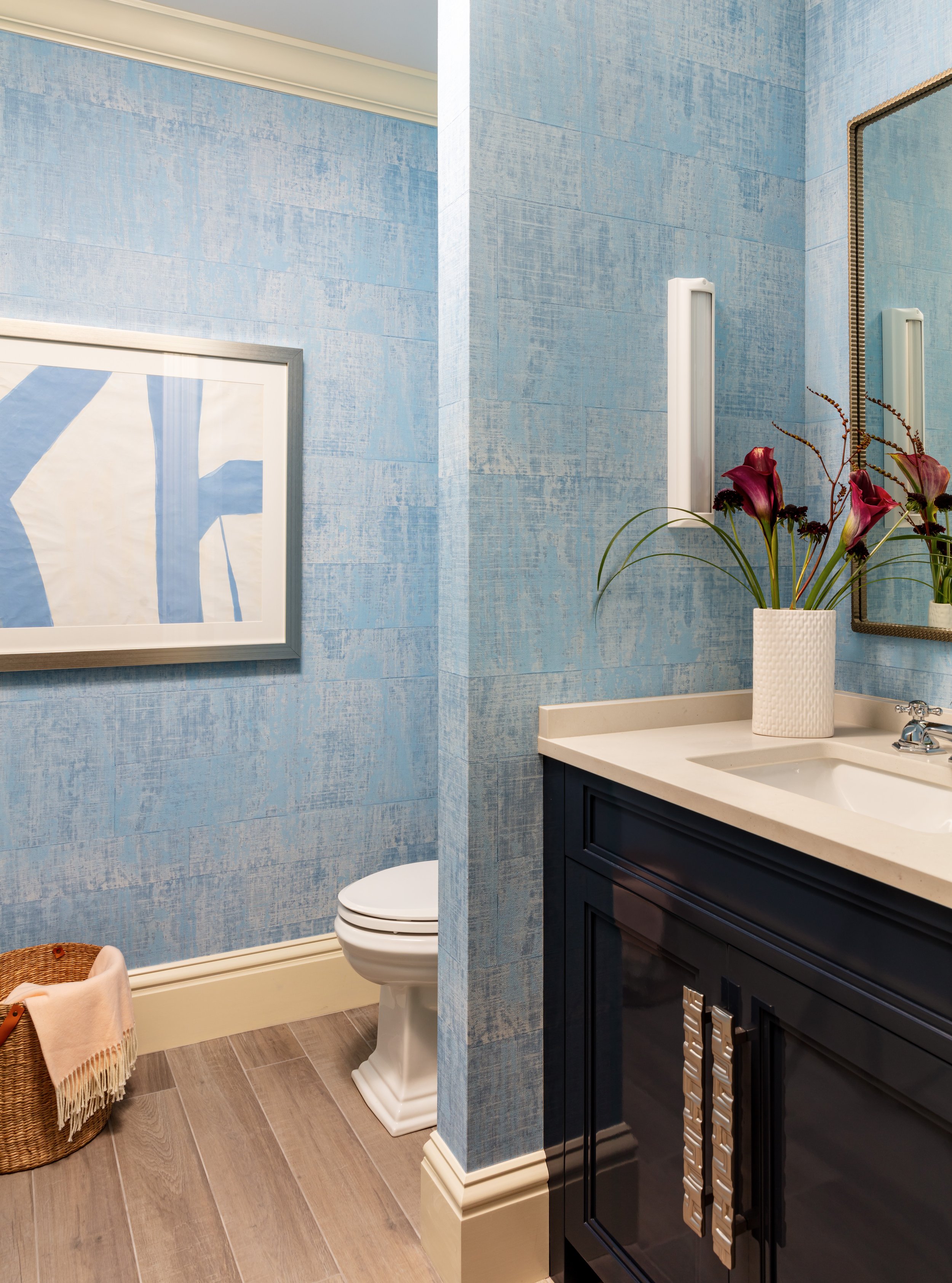 powder-room-renovation-design-with-blue-wallpaper-painted-vanity-and-statement-hardware.jpg