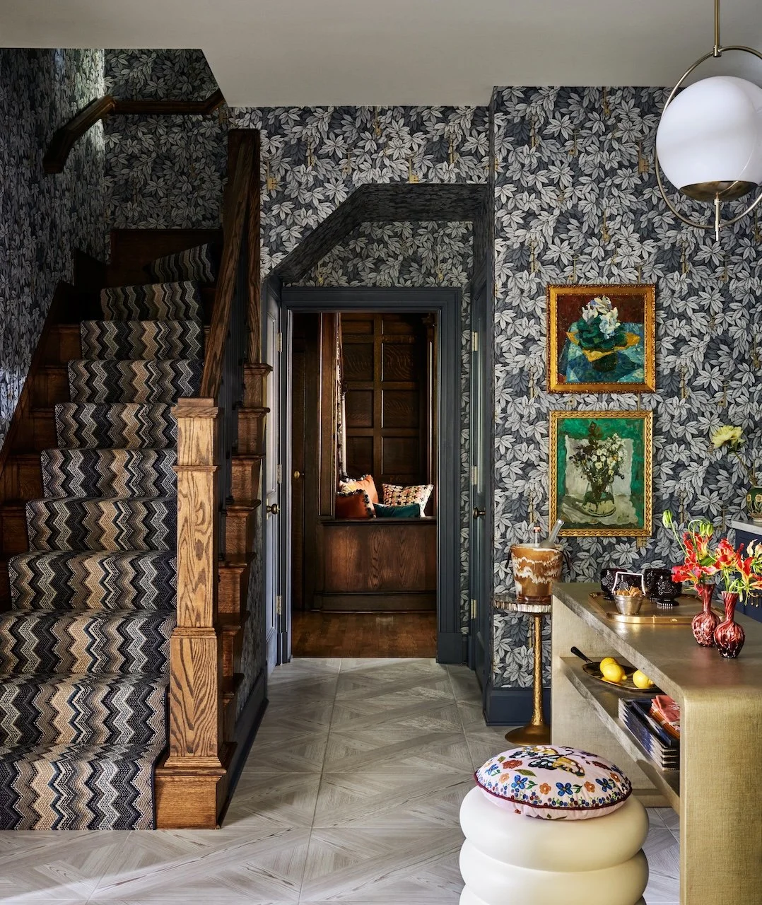 Dramatic pantry leaf-wallpaper chevron stair runner navy trim oak newel globe pendant