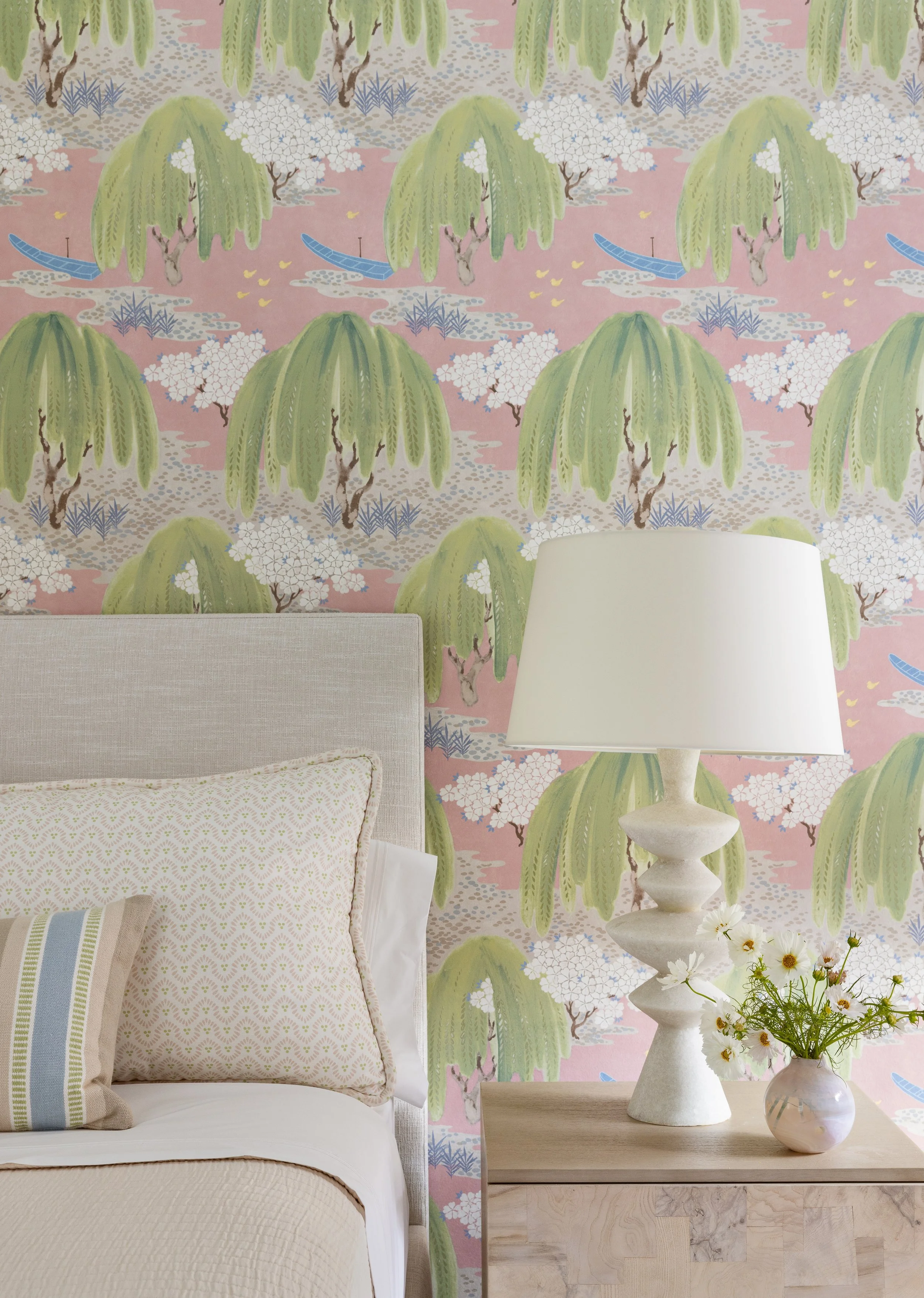 cozy bedroom soft pastel wallpaper comfortable bedding end table and lamp