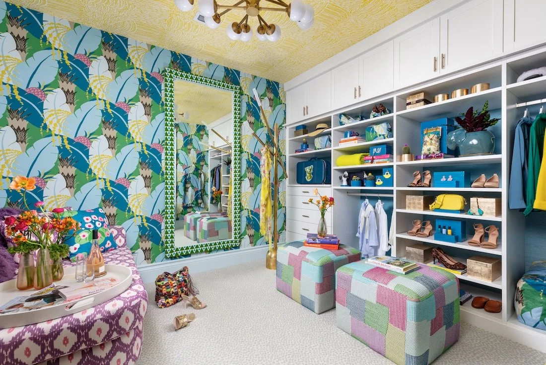 tropical-print-walk-in-closet-white-built-ins-mirror-patchwork-ottomans.jpg