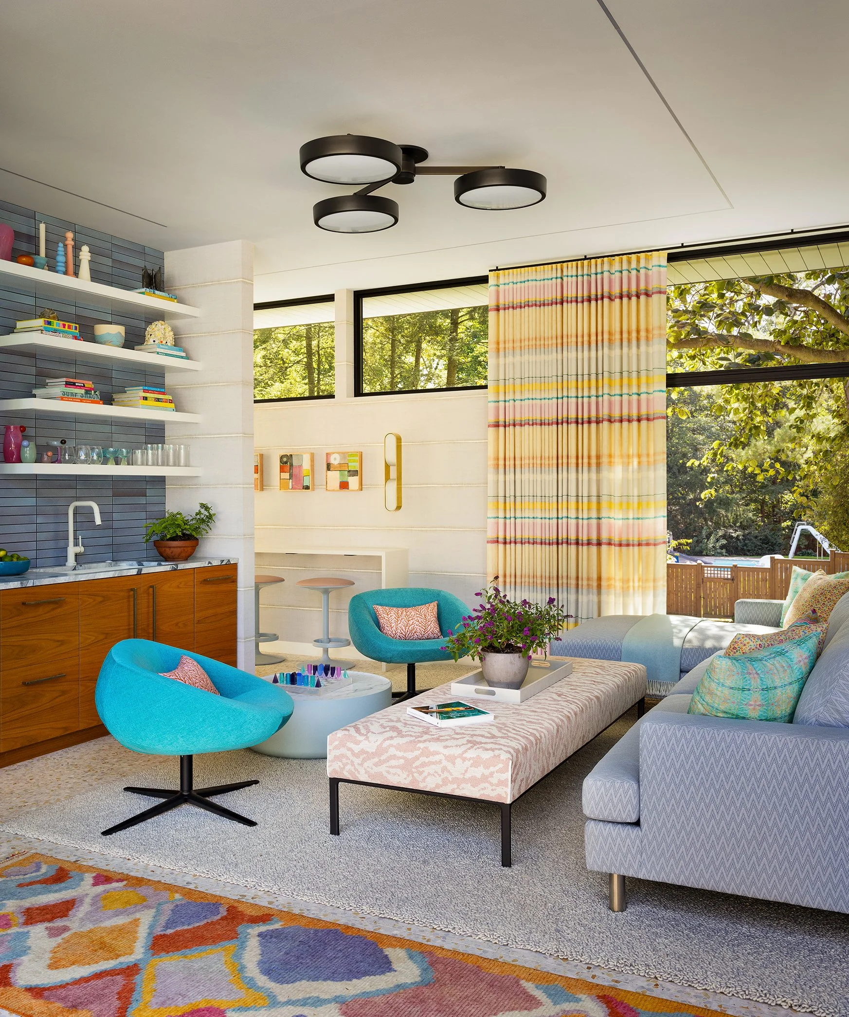 modern pool house with comfortable seating and bar area with tiled backsplash and open shelving