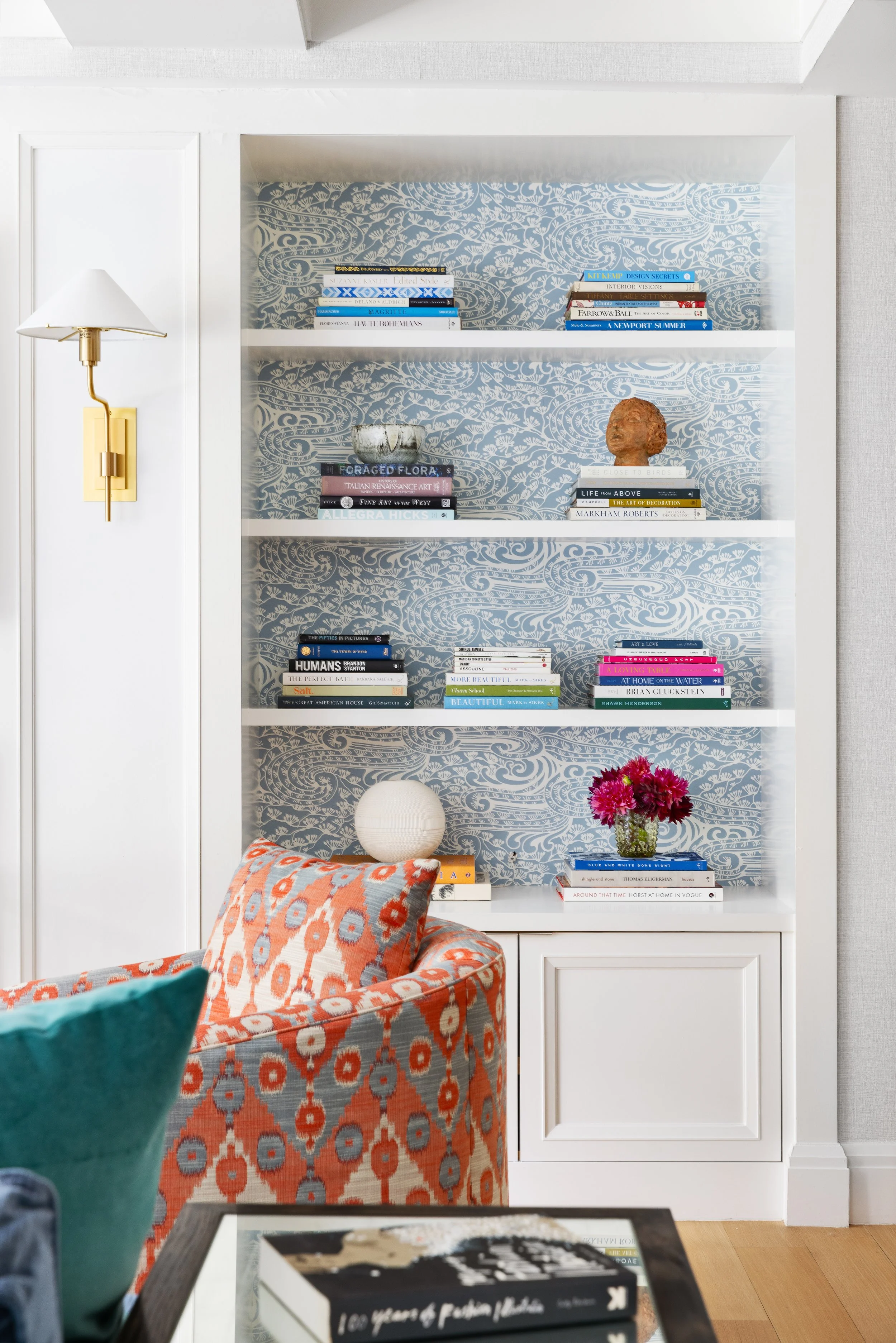 chic-bookcase-with-wallpaper-colorful-chair.jpeg